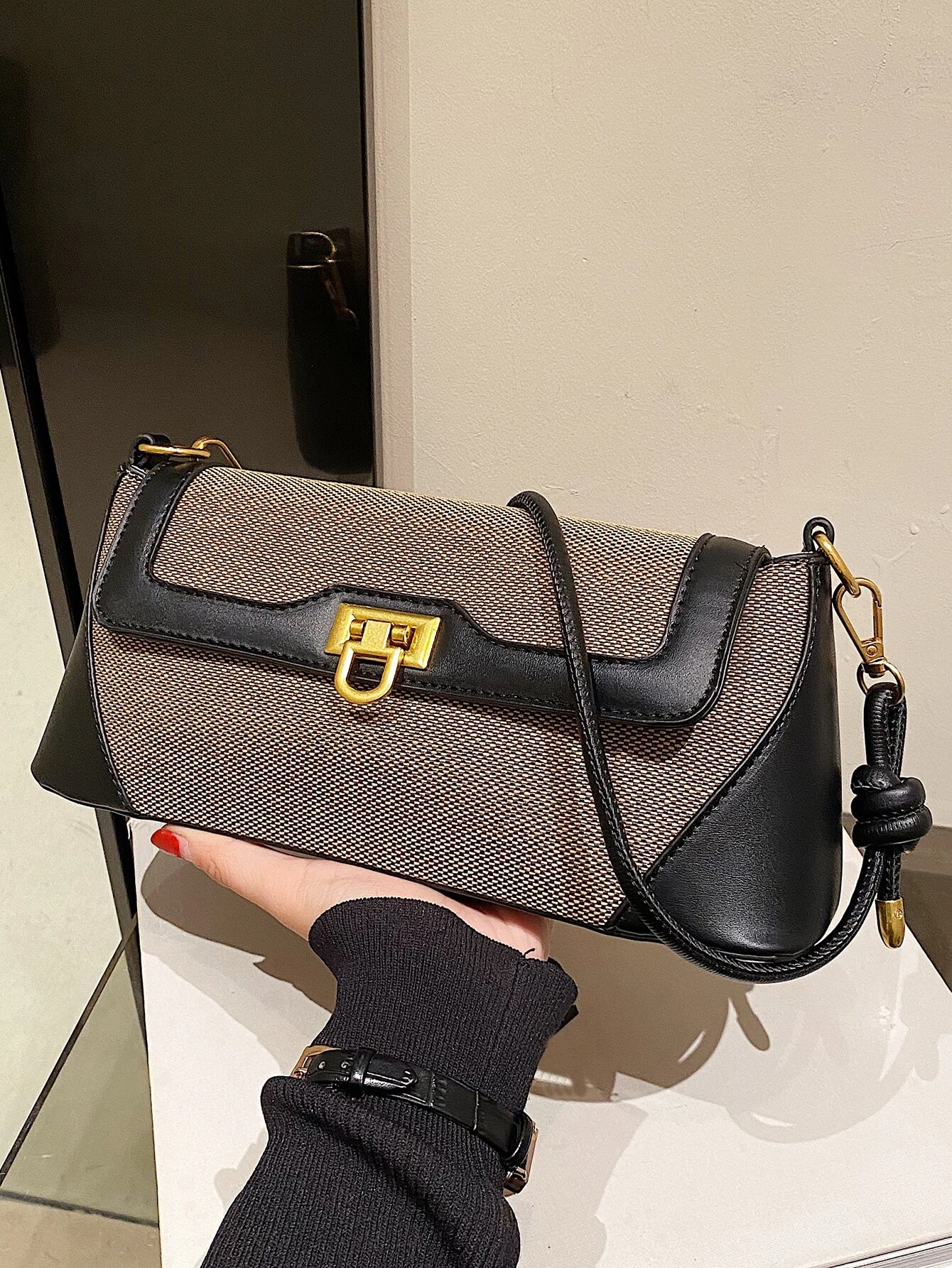 Two-tone flap baguette bag with a blend of colors. This accessory offers a sleek and stylish way to carry your essentials, embodying modern elegance and functionality.