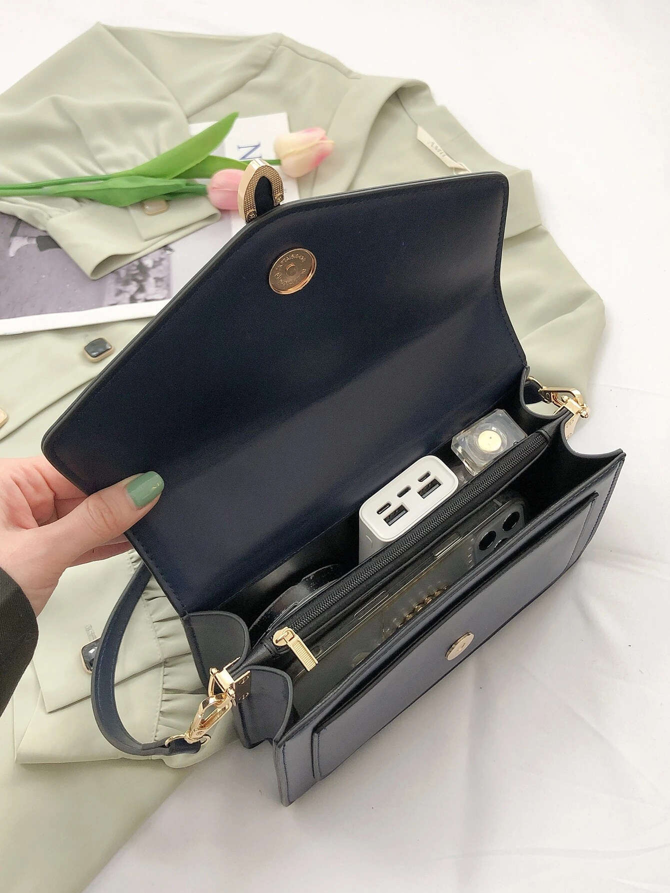 Minimalist navy blue square bag with metal decorative elements and flap closure. This accessory combines modern design with stylish embellishments, offering a chic and visually appealing way to carry your essentials.