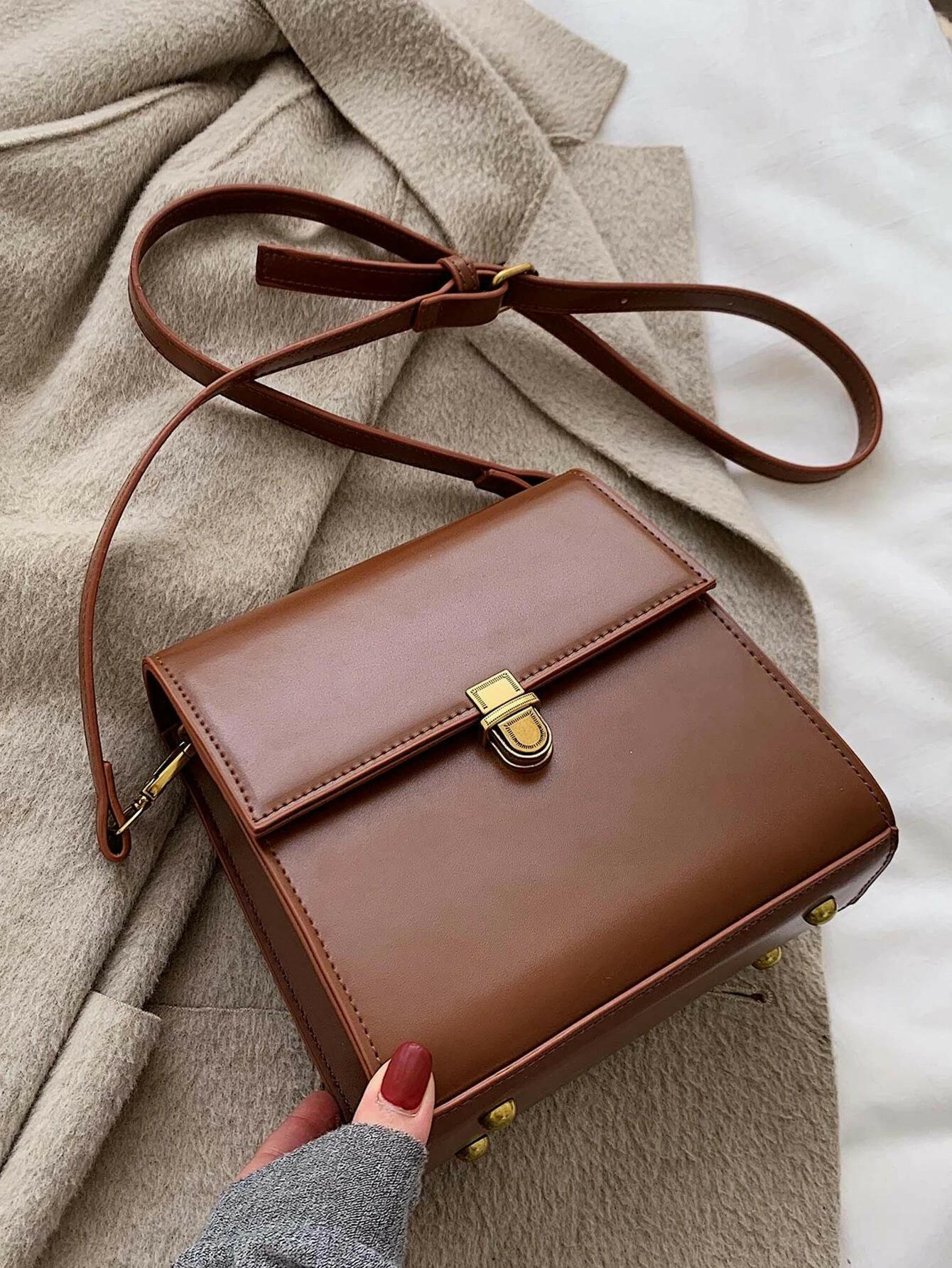 Push lock crossbody bag with minimalist design. This accessory combines practicality with clean lines, offering a sleek and versatile way to carry your essentials.
