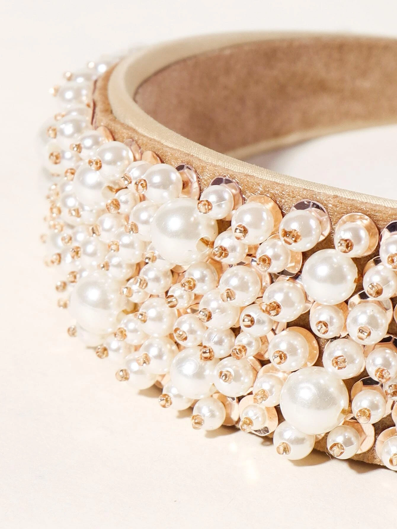 A hair hoop adorned with faux pearl beads, providing a chic and elegant accessory for your hair styling.