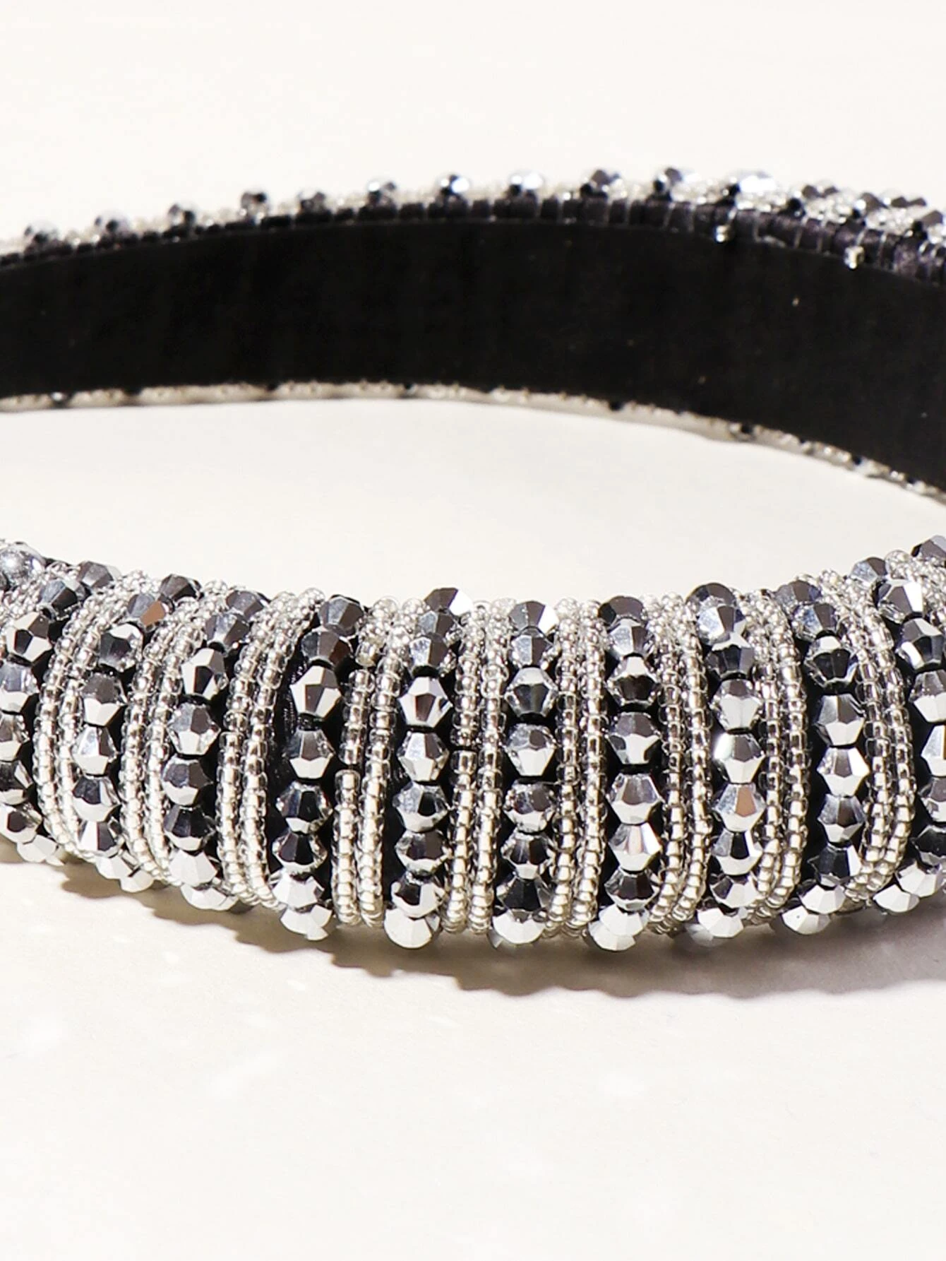 A hair hoop embellished with beads, creating a stylish and eye-catching accessory for your hair.