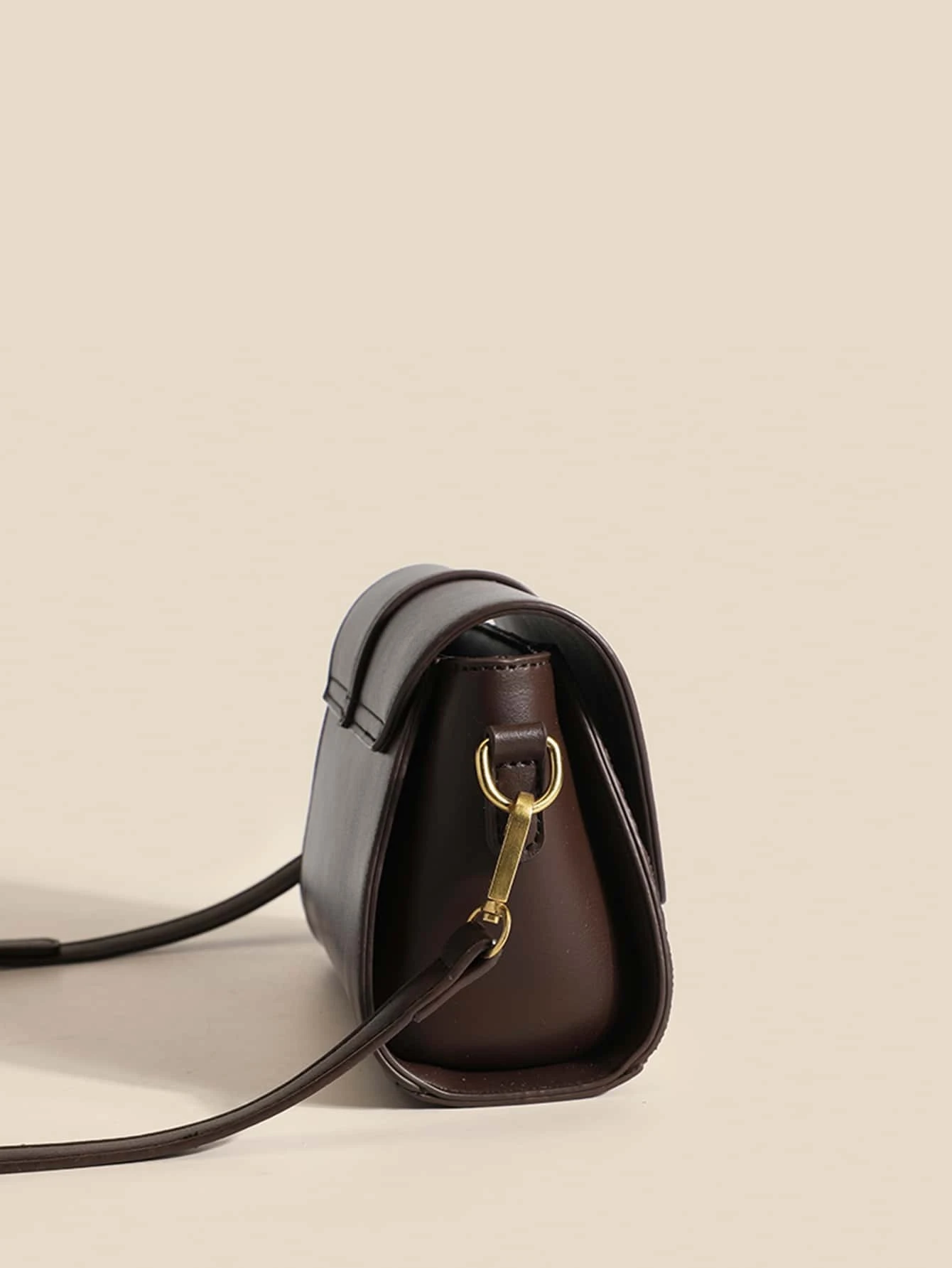 Mini square bag with houndstooth pattern flap. This accessory combines classic design with modern elements, offering a chic and stylish way to carry your essentials.