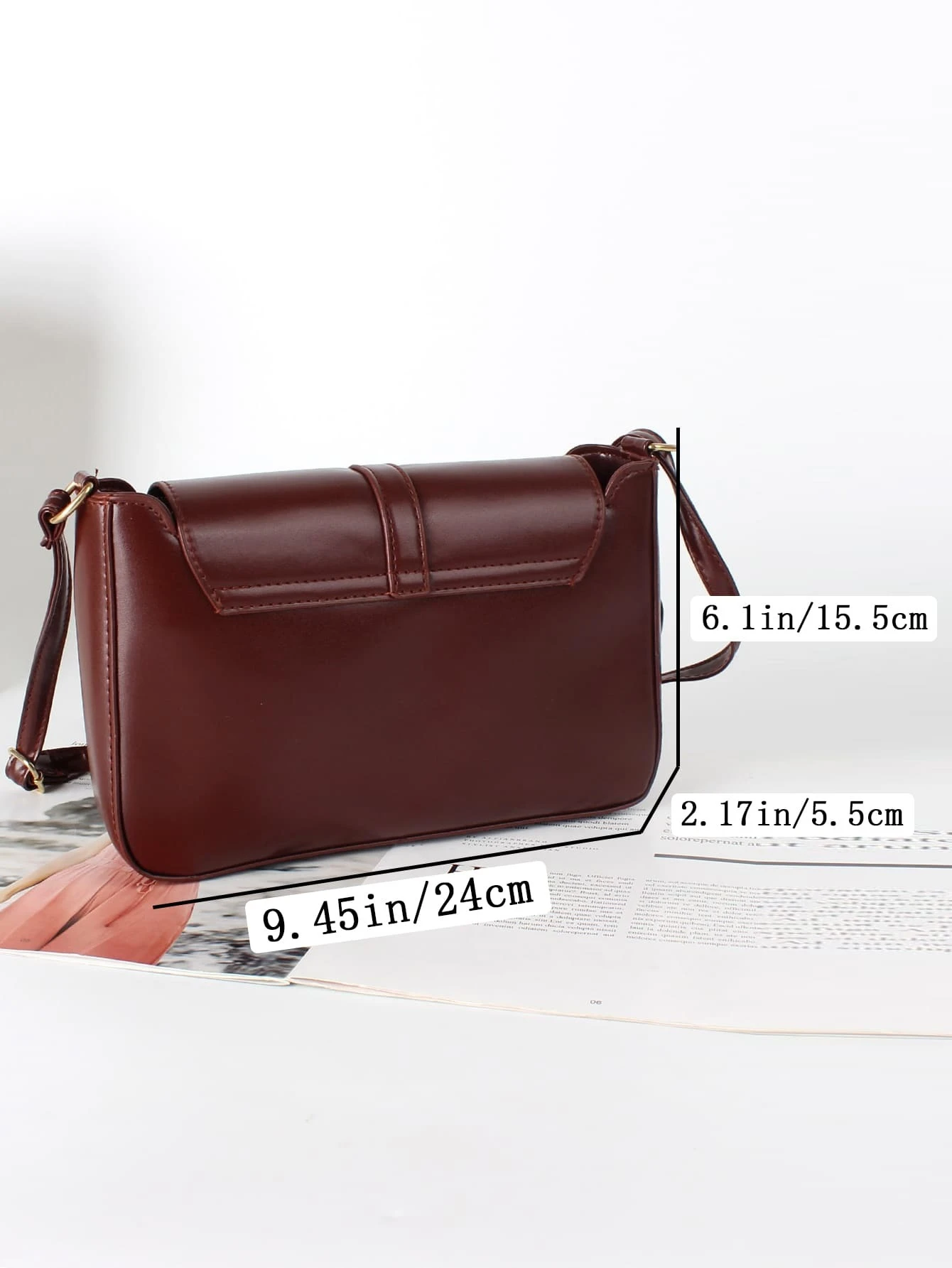 Flap crossbody bag with decorative buckle accent. This bag combines practicality and fashion, featuring a flap closure adorned with a stylish buckle for a chic and functional accessory.