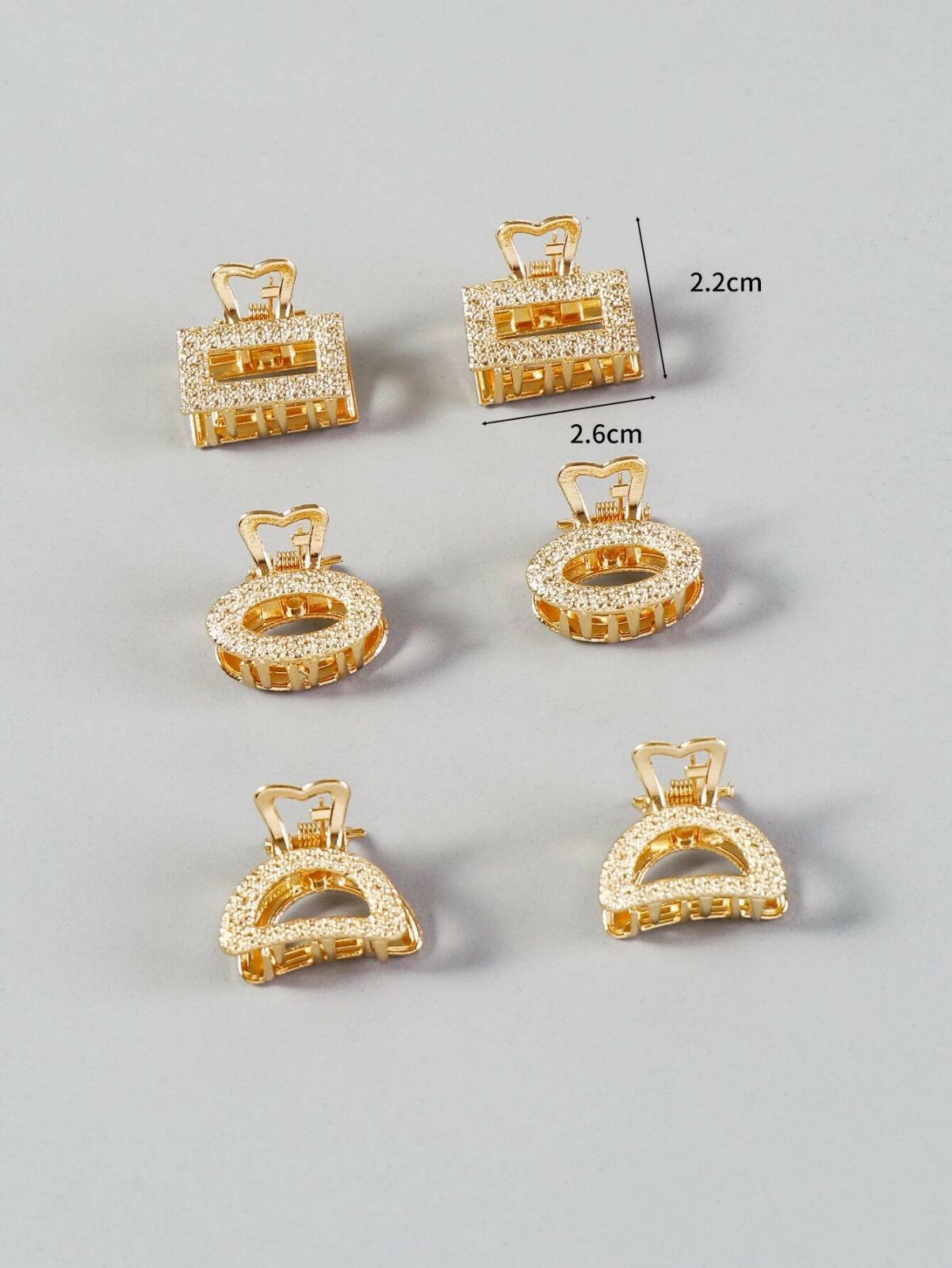 A set of six metallic hair claws, providing a sleek and modern way to secure and style your hair with a touch of shine.