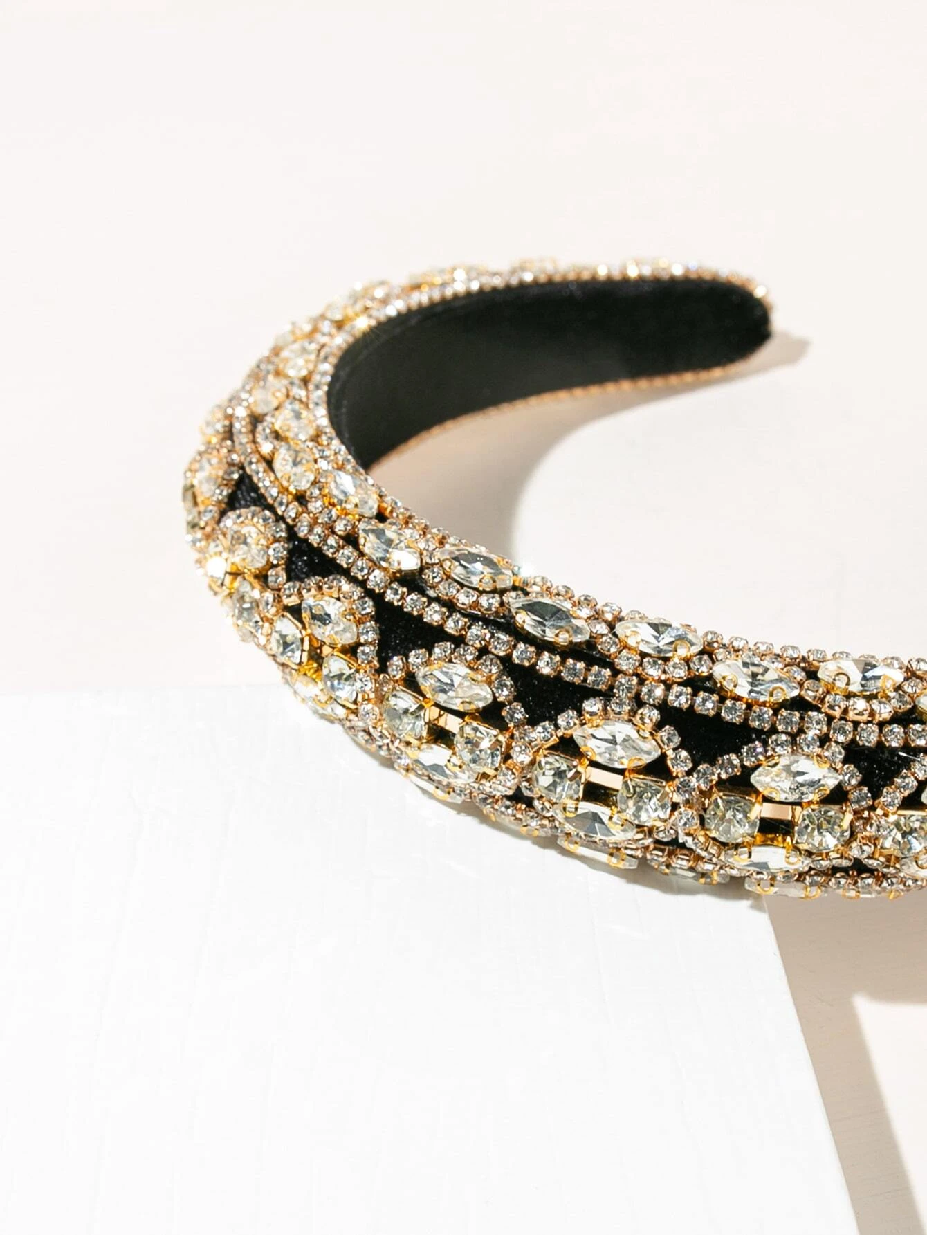 Headband adorned with rhinestones, providing a touch of elegance and sparkle to your hair look.
