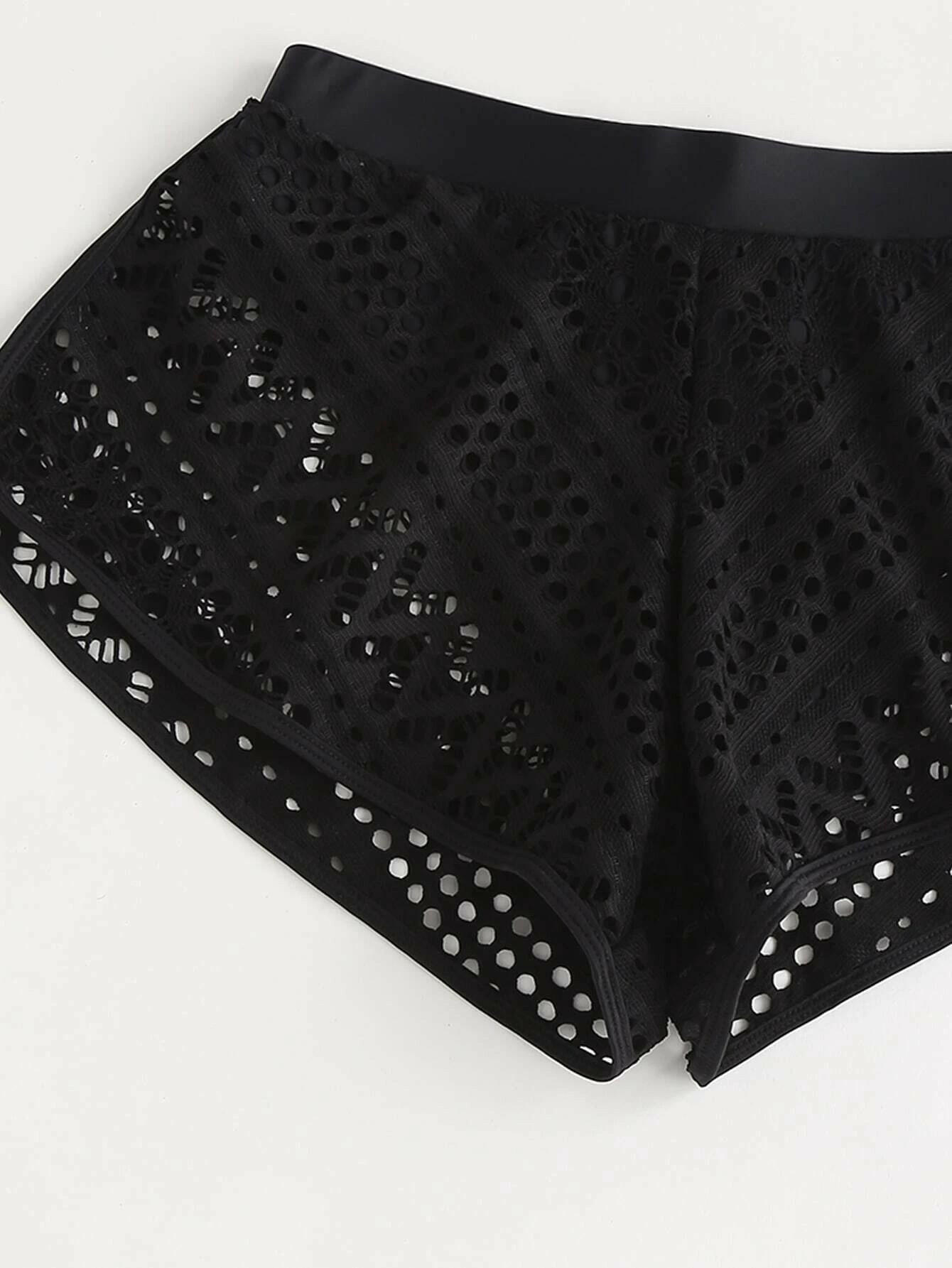 Black bikini shorts with stylish hollow-out detailing. These shorts showcase a chic and edgy design, featuring intricate hollow-out patterns against a black backdrop. The cut and style provide a comfortable and flattering fit, making them a trendy choice for swimwear. The hollow-out elements add a touch of flair to the classic black bikini shorts, perfect for a bold and fashionable beach or poolside statement.