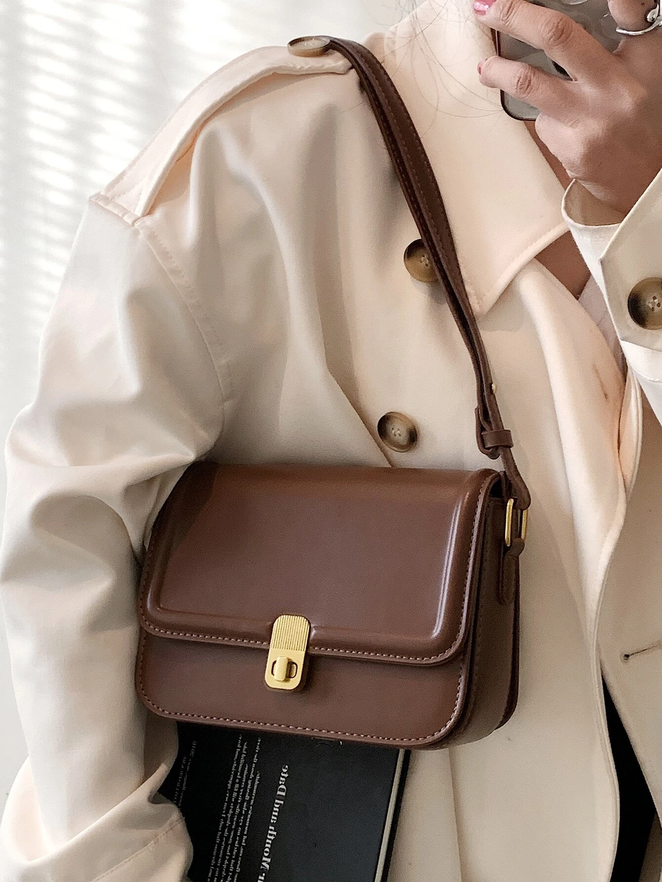 Square bag with twist lock flap closure. This accessory offers a chic and stylish way to carry your essentials, featuring a secure twist lock that enhances its functionality.