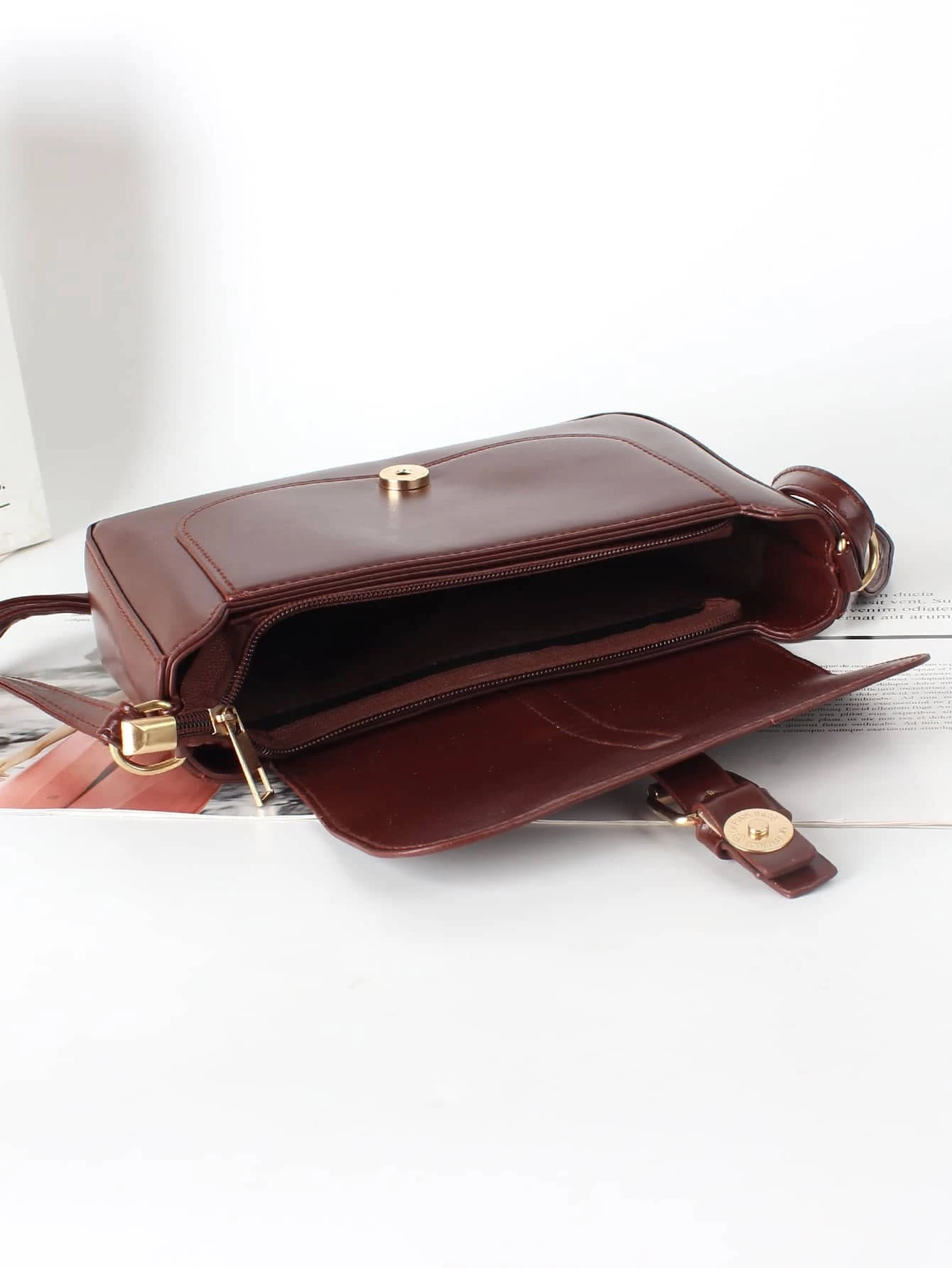 Flap crossbody bag with decorative buckle accent. This bag combines practicality and fashion, featuring a flap closure adorned with a stylish buckle for a chic and functional accessory.