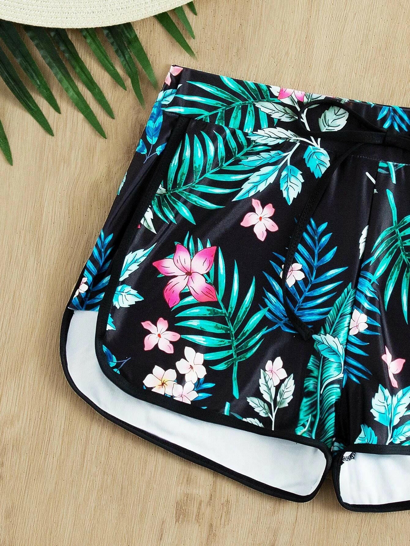 Tropical print swim shorts with vibrant and exotic patterns. These swim shorts showcase a lively tropical design, perfect for a beach or poolside vibe. The vibrant print adds a touch of color and energy to the swimwear, making them a stylish and eye-catching choice for water-related activities.
