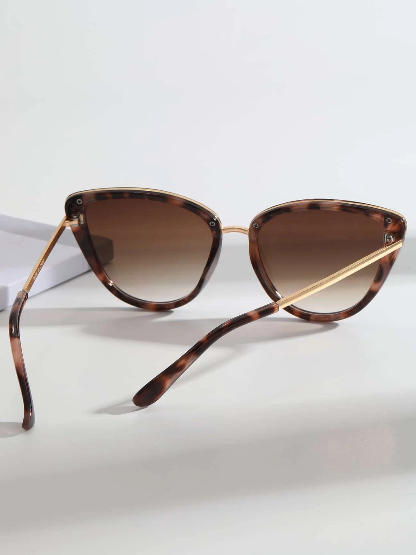 Pair of Cat Eye Tinted Lens Sunglasses with a stylish and bold design. These sunglasses showcase the iconic cat-eye frame shape and feature tinted lenses, providing both fashion and sun glare protection.