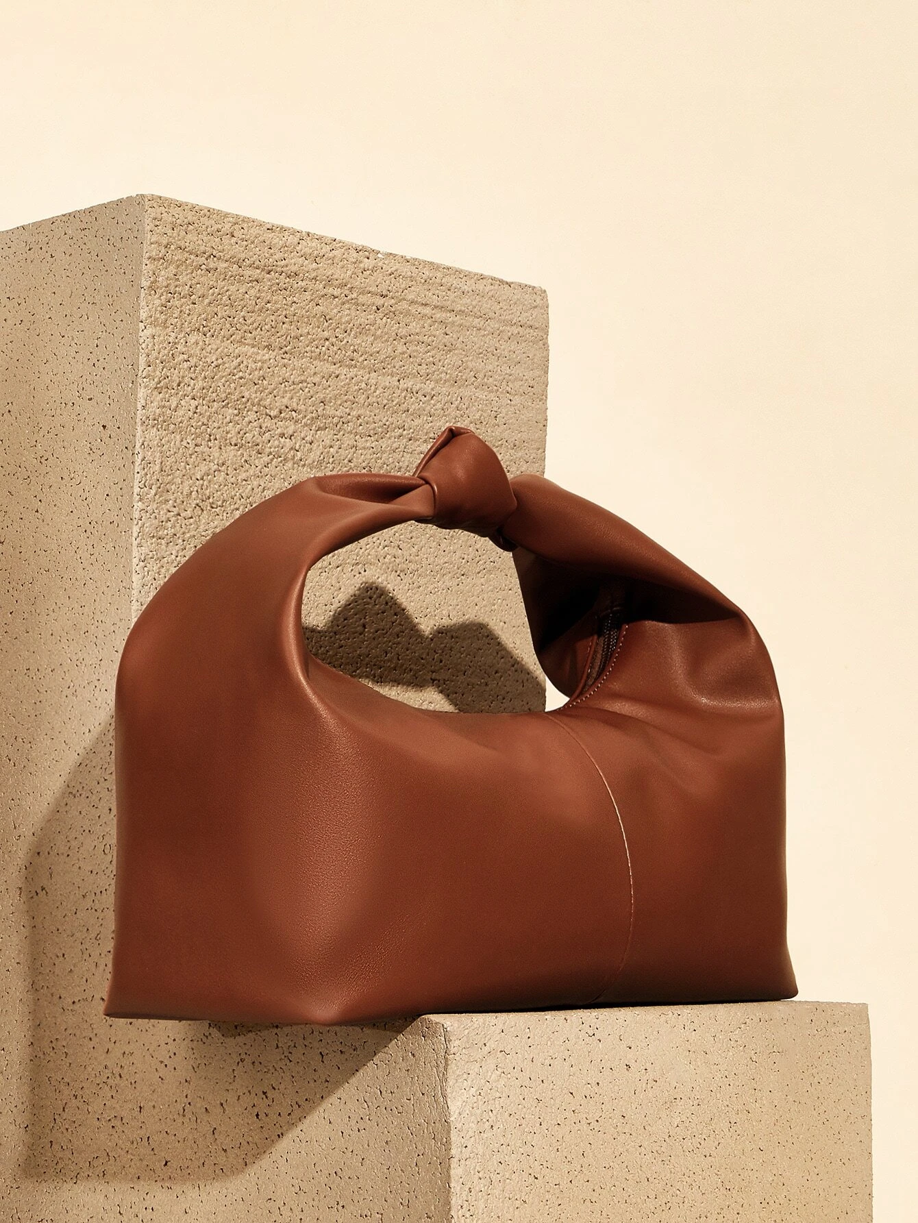 Minimalist baguette bag with clean lines and sleek design. This accessory offers a simple yet stylish way to carry your essentials, embodying modern elegance and functionality.