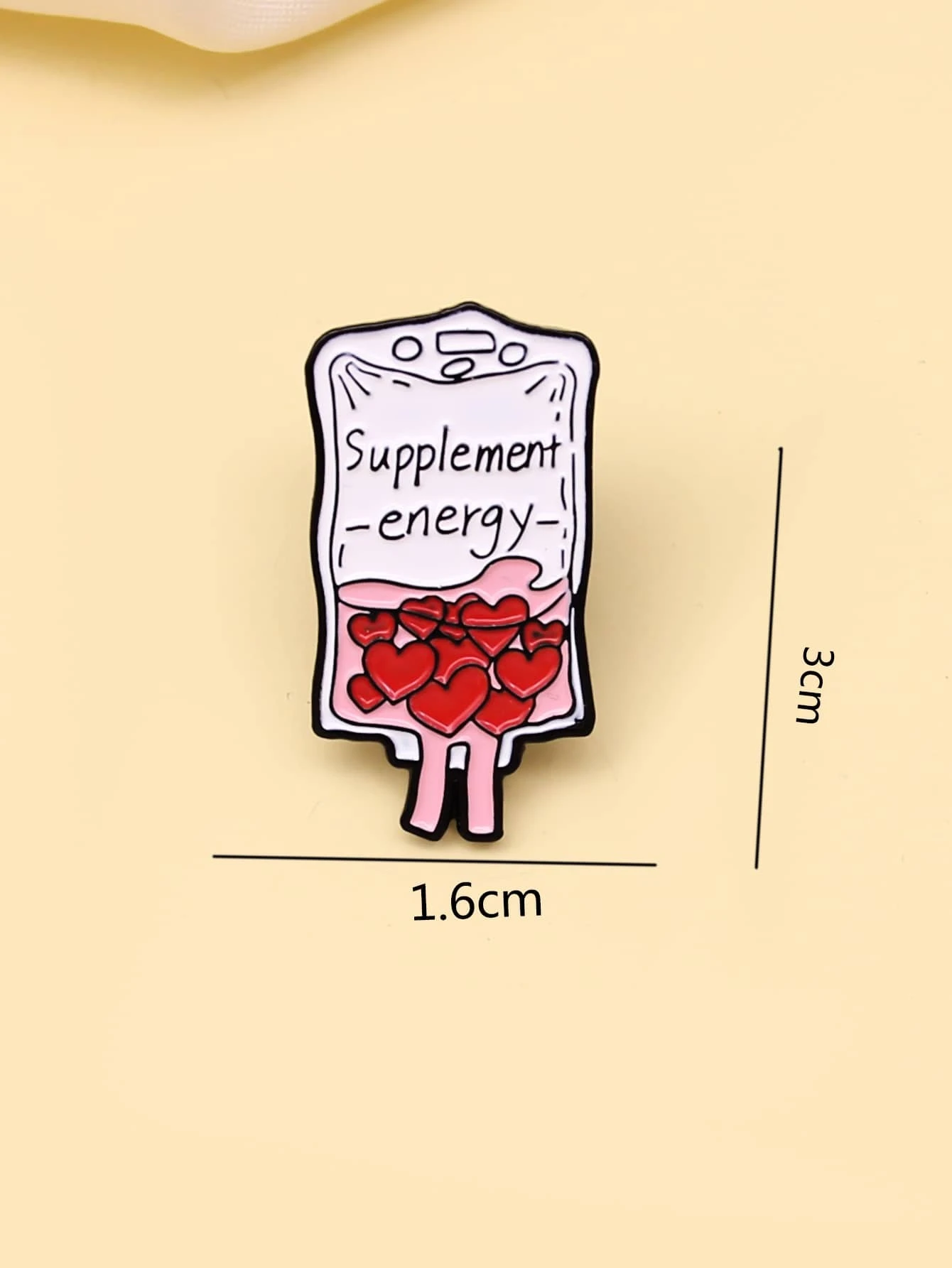 Brooch featuring a combination of heart and letter graphics, creating a charming and personalized accessory with a touch of romantic sentiment.