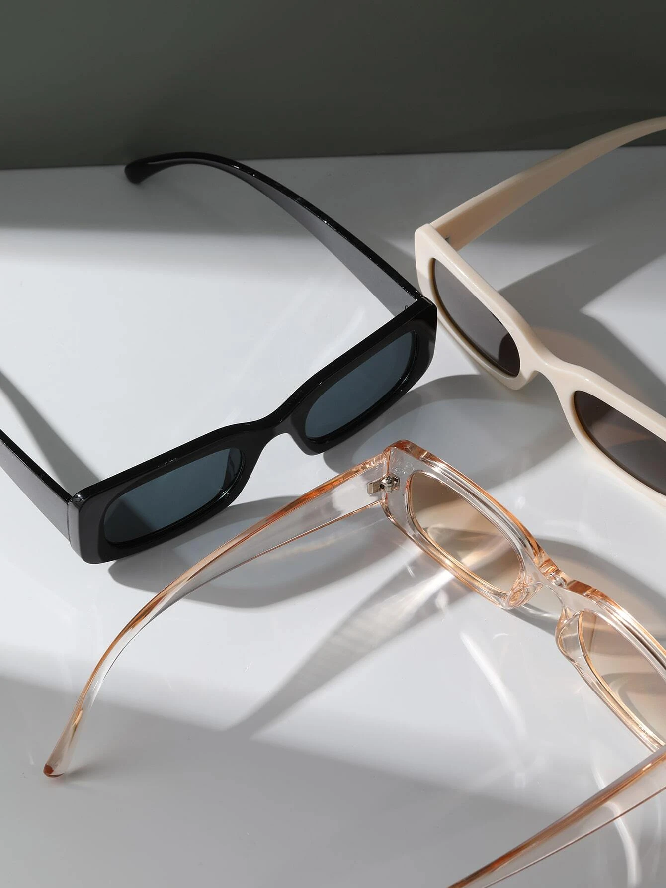 Three pairs of Square Frame Sunglasses featuring different color combinations. Square frames add a touch of boldness to your accessory collection while providing essential sun protection.