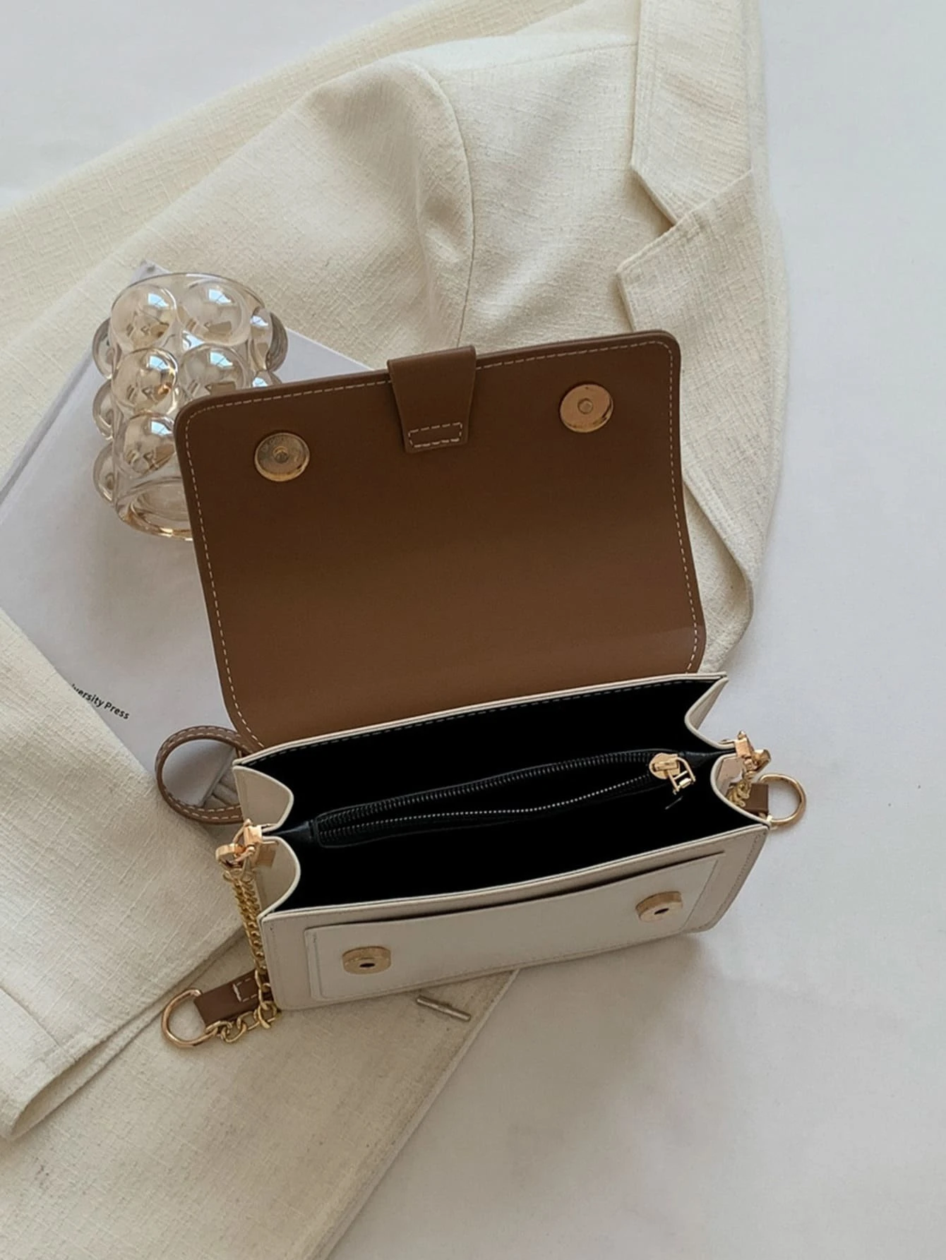 Mini square bag with color block flap design. This accessory combines modern design with vibrant color contrasts, offering a chic and stylish way to carry your essentials.