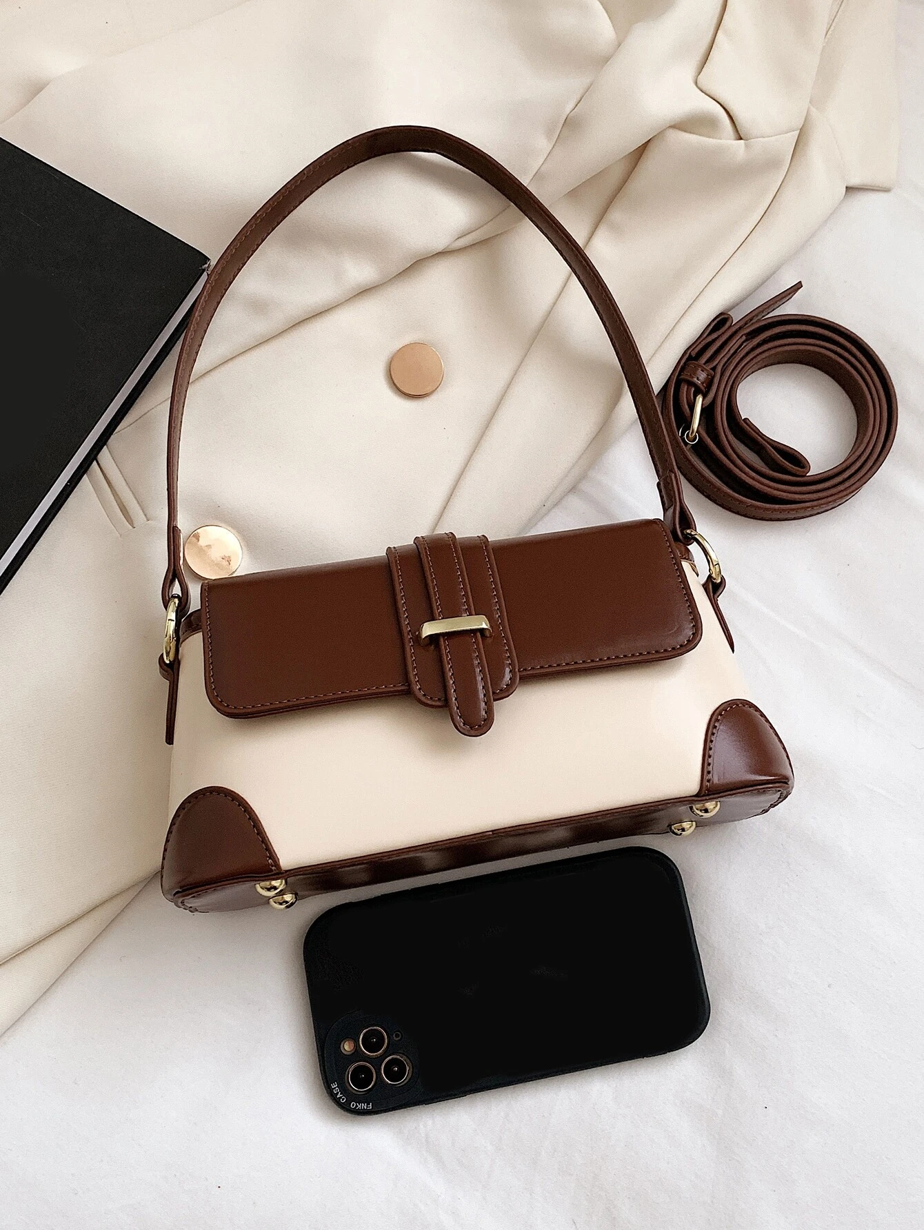 Square bag with colorblock flap design. This accessory boasts a modern and dynamic look, featuring contrasting color panels that add visual interest and style to your ensemble.