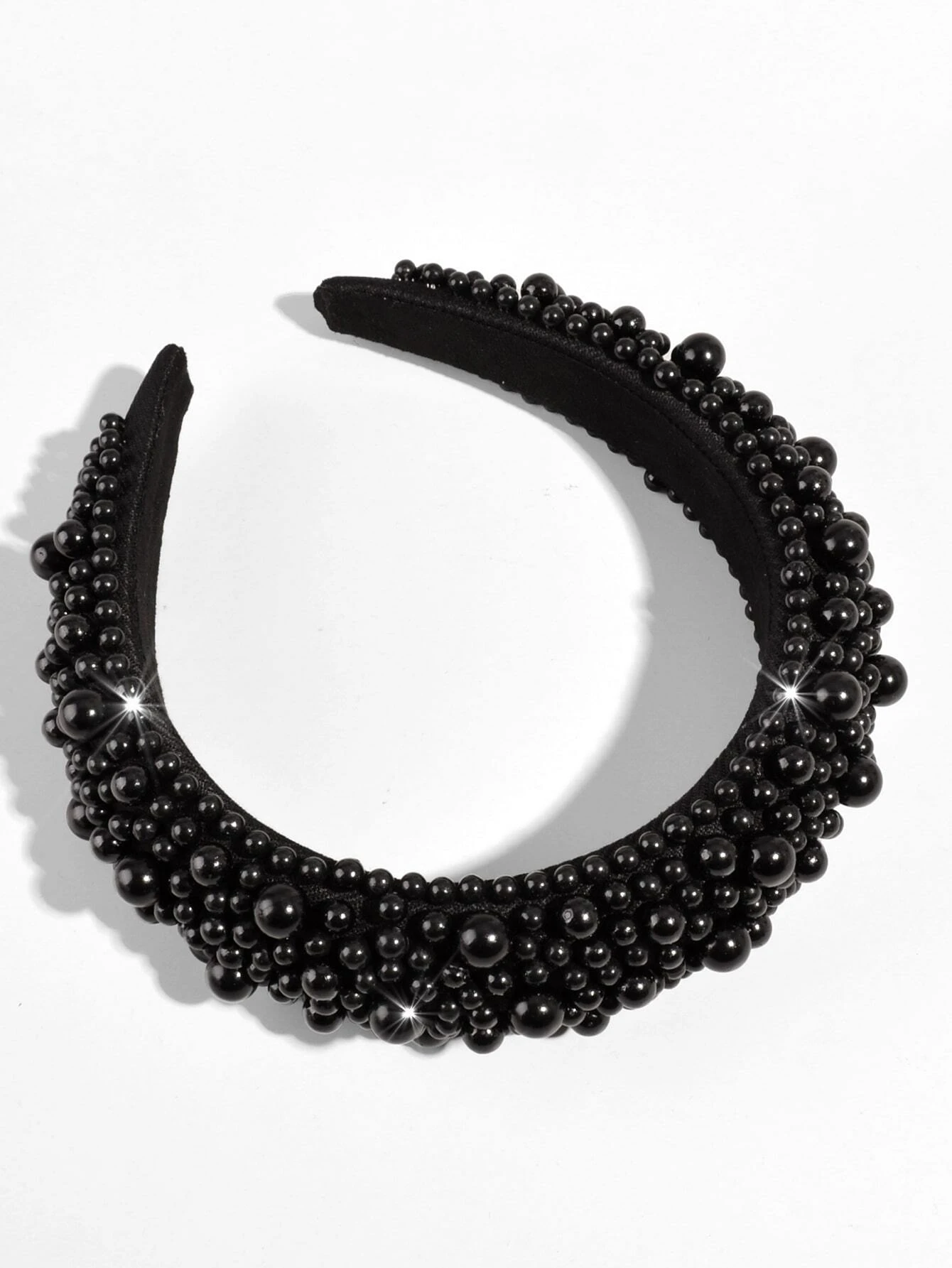 A black headband adorned with bead decorations, offering a chic and stylish accessory for your hair.