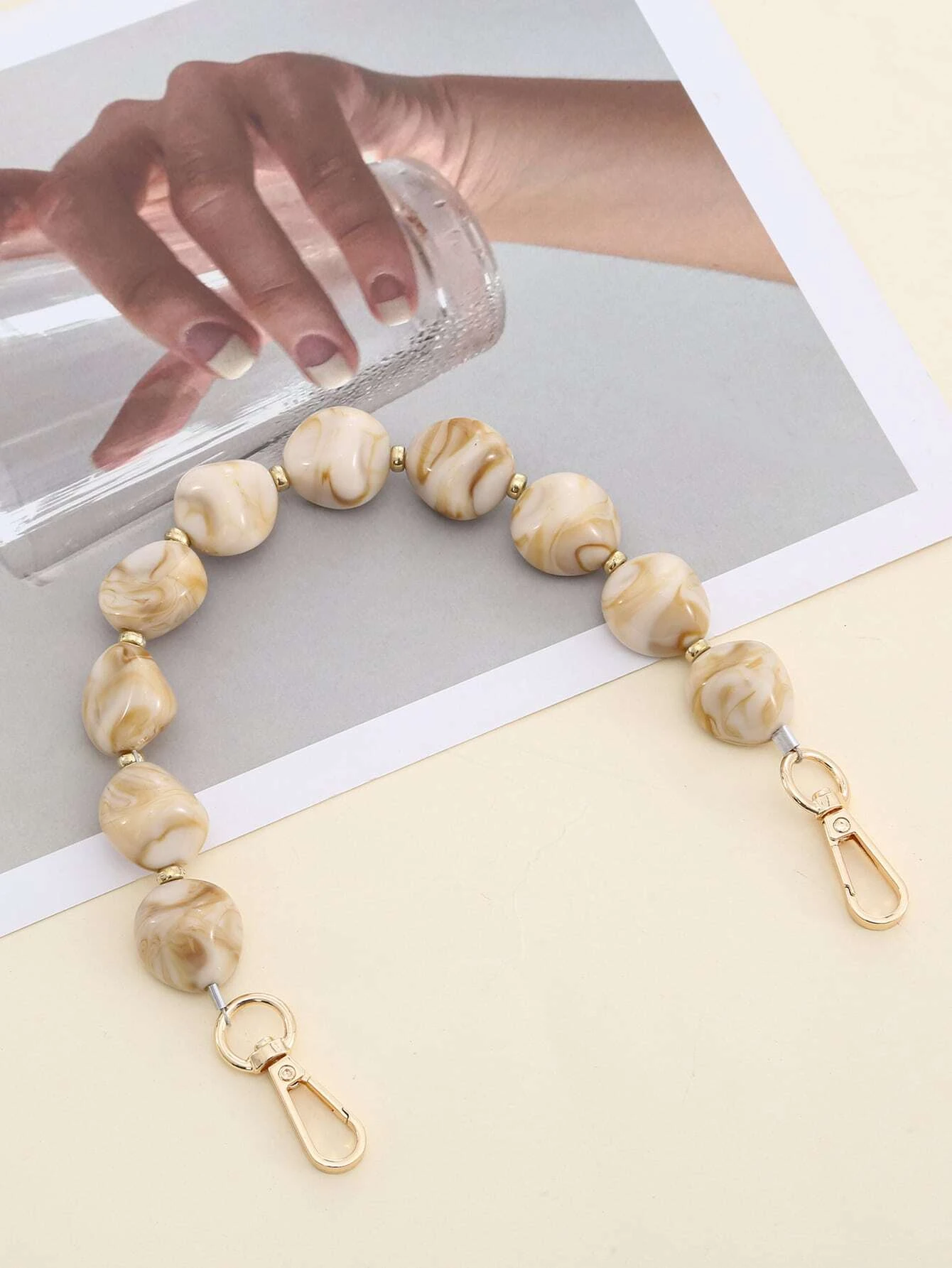 Bag strap adorned with stylish graphic beading. This accessory adds a touch of artistic design to your bag, with its intricate beadwork enhancing its visual appeal.