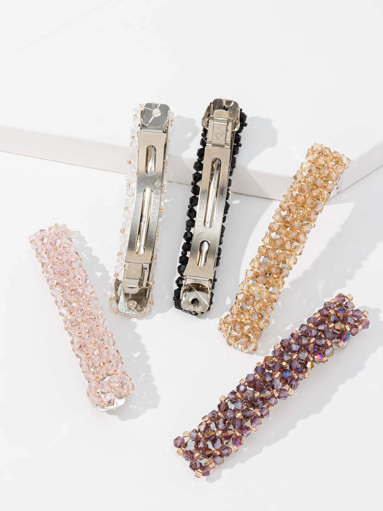 A set of five hair clips adorned with crystal decorations, adding a touch of sparkle and elegance to your hair styling.