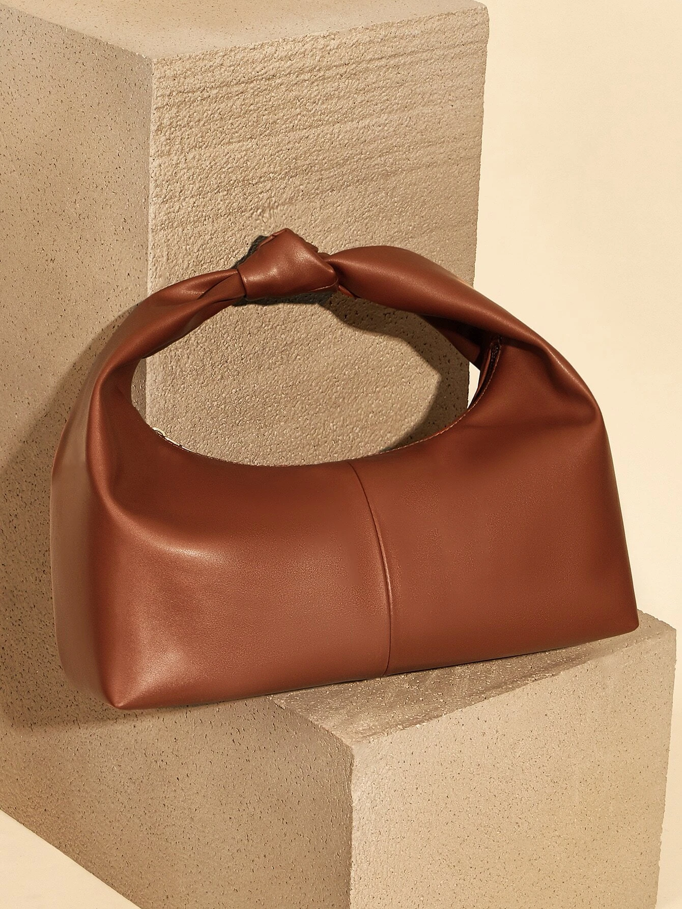 Minimalist baguette bag with clean lines and sleek design. This accessory offers a simple yet stylish way to carry your essentials, embodying modern elegance and functionality.