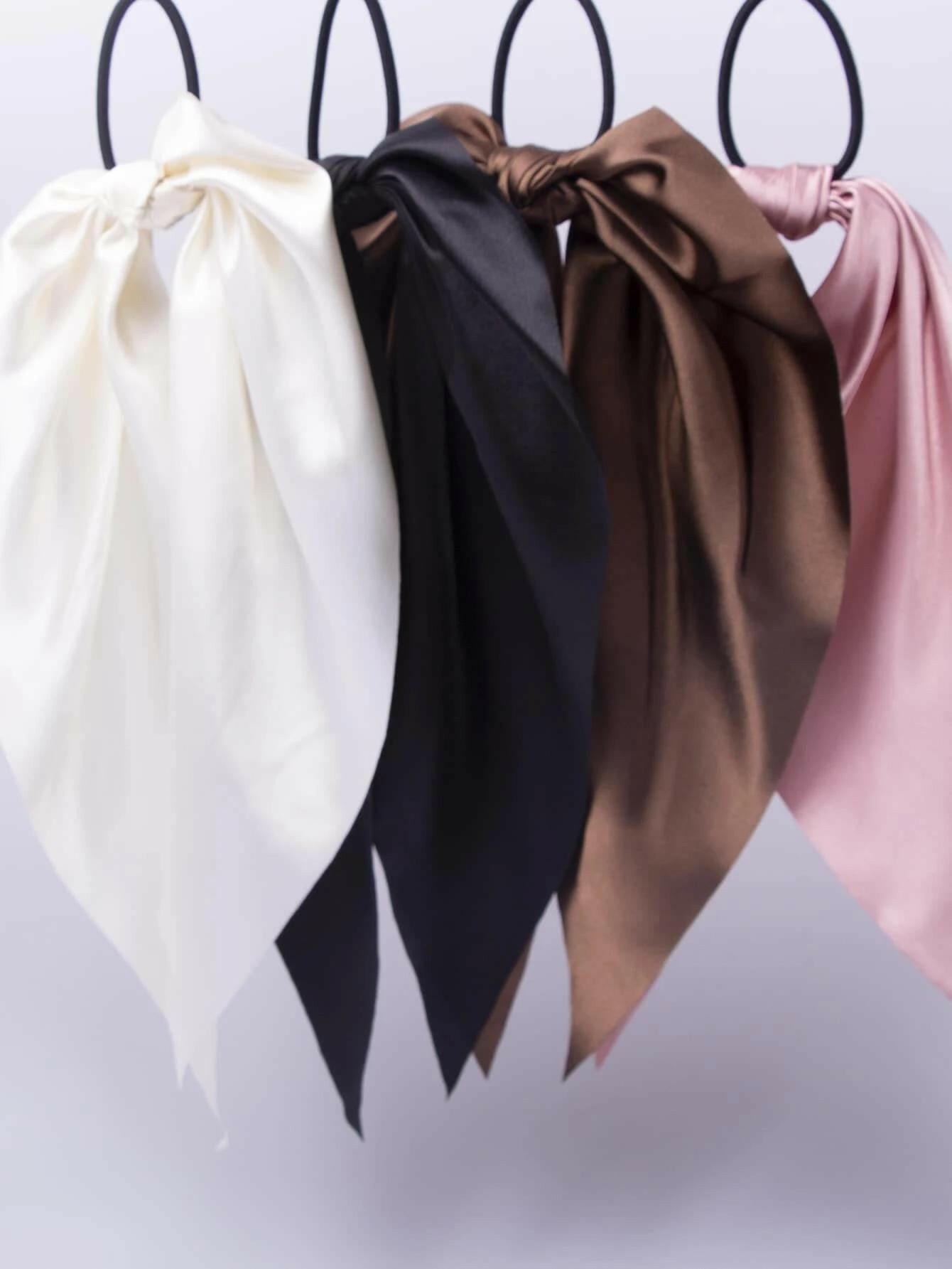 A collection of four knot-style hair ties, providing a simple yet fashionable way to secure and style your hair.