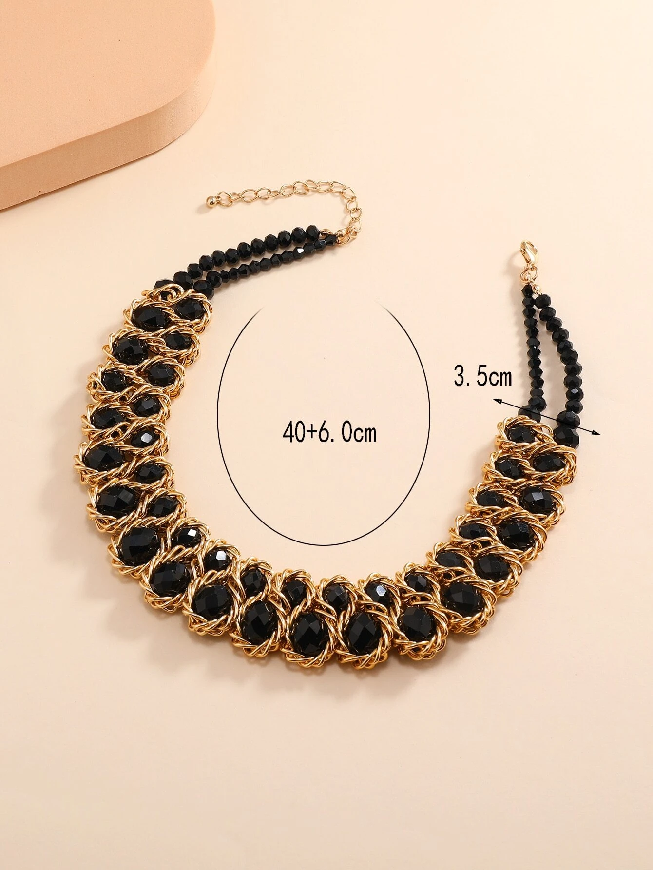 A necklace adorned with crystal decorations. The necklace features clear or colored crystals arranged in an artistic and eye-catching pattern. This accessory is elegant and versatile, adding a touch of sparkle and sophistication to various outfits.