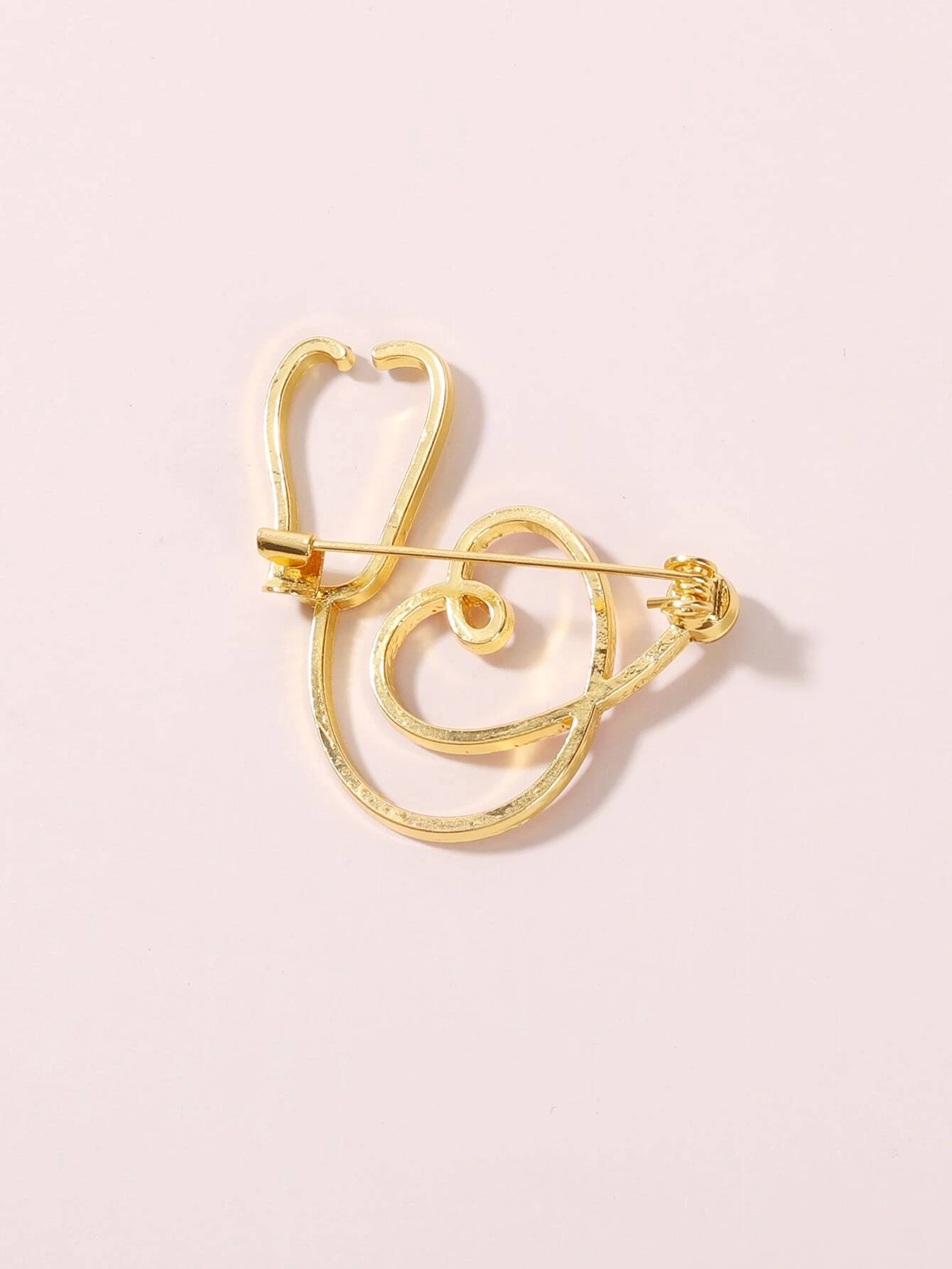 Brooch featuring a stethoscope design, a symbolic and stylish accessory for healthcare professionals or those who appreciate their dedication.