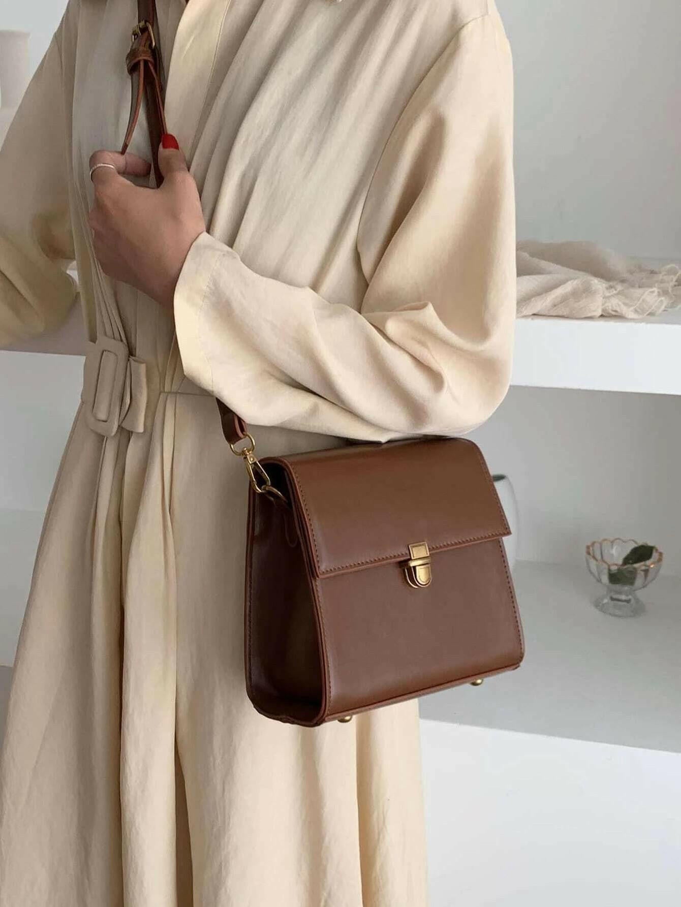 Push lock crossbody bag with minimalist design. This accessory combines practicality with clean lines, offering a sleek and versatile way to carry your essentials.