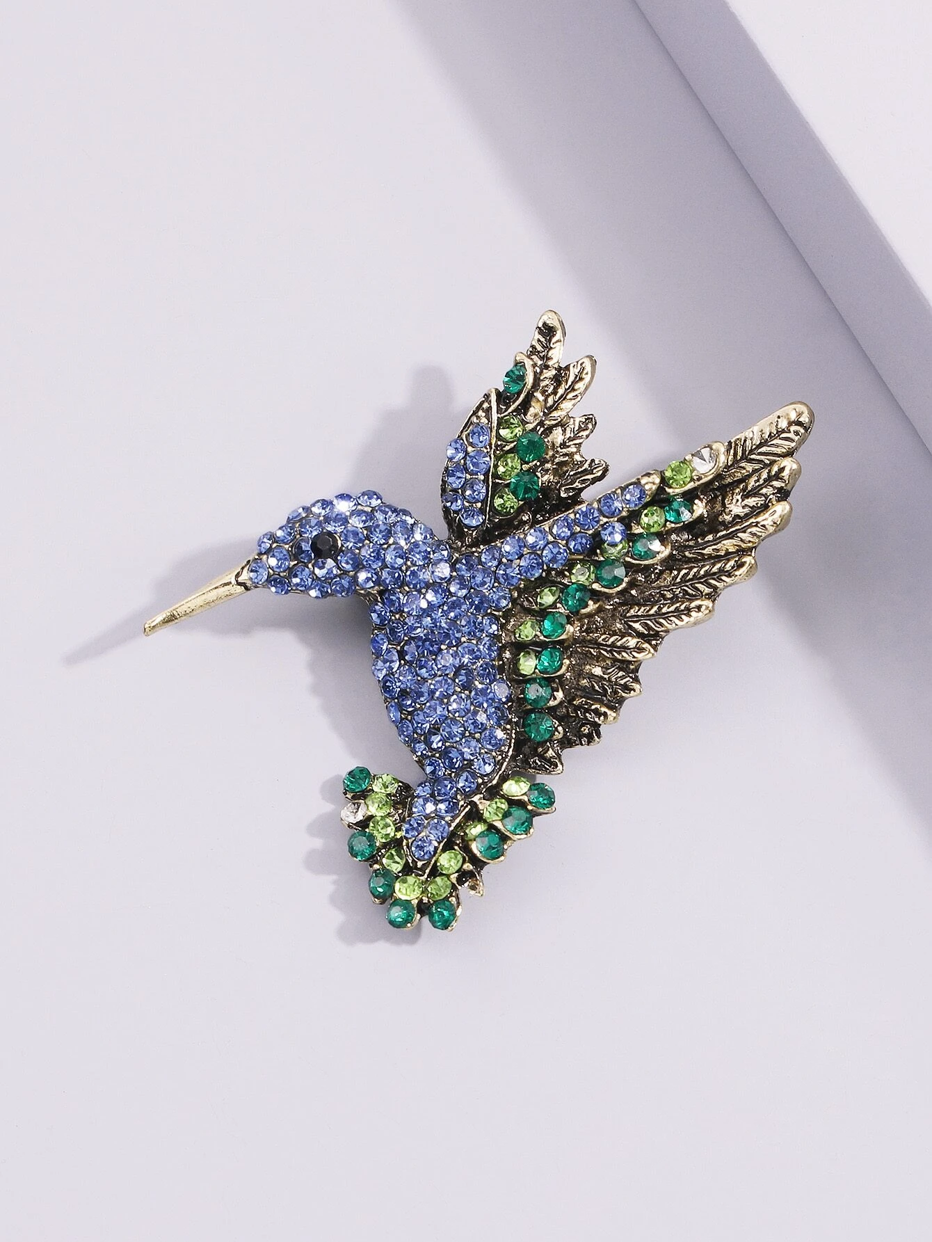 Brooch adorned with a bird design, embellished with sparkling rhinestones for a touch of elegance and nature-inspired beauty.