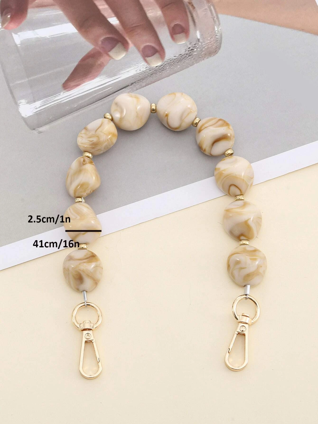 Bag strap adorned with stylish graphic beading. This accessory adds a touch of artistic design to your bag, with its intricate beadwork enhancing its visual appeal.