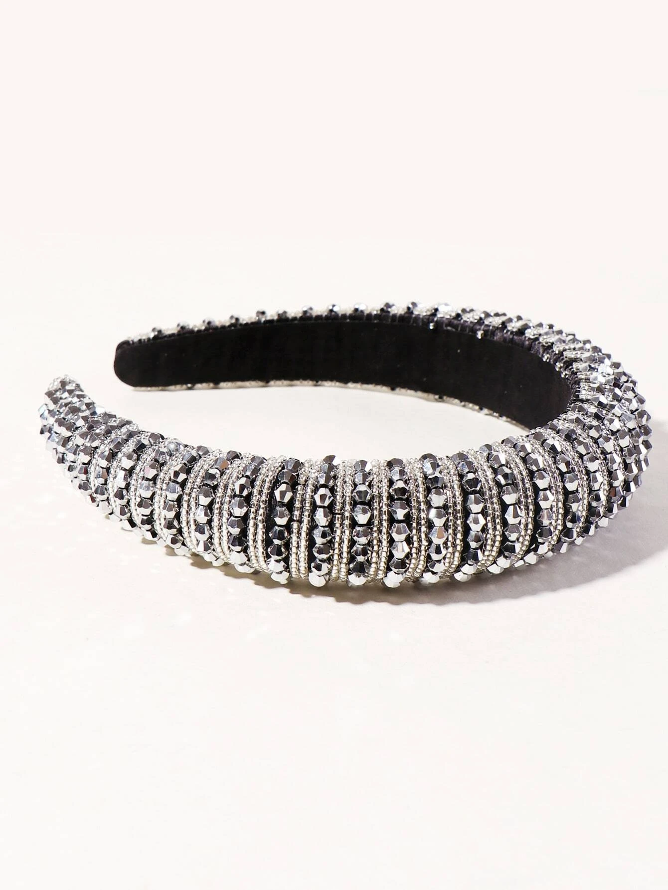 A hair hoop embellished with beads, creating a stylish and eye-catching accessory for your hair.