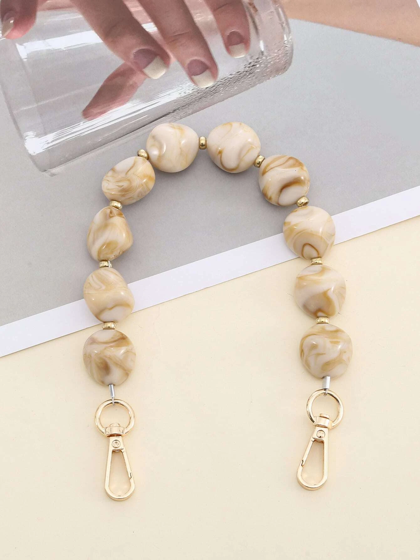 Bag strap adorned with stylish graphic beading. This accessory adds a touch of artistic design to your bag, with its intricate beadwork enhancing its visual appeal.