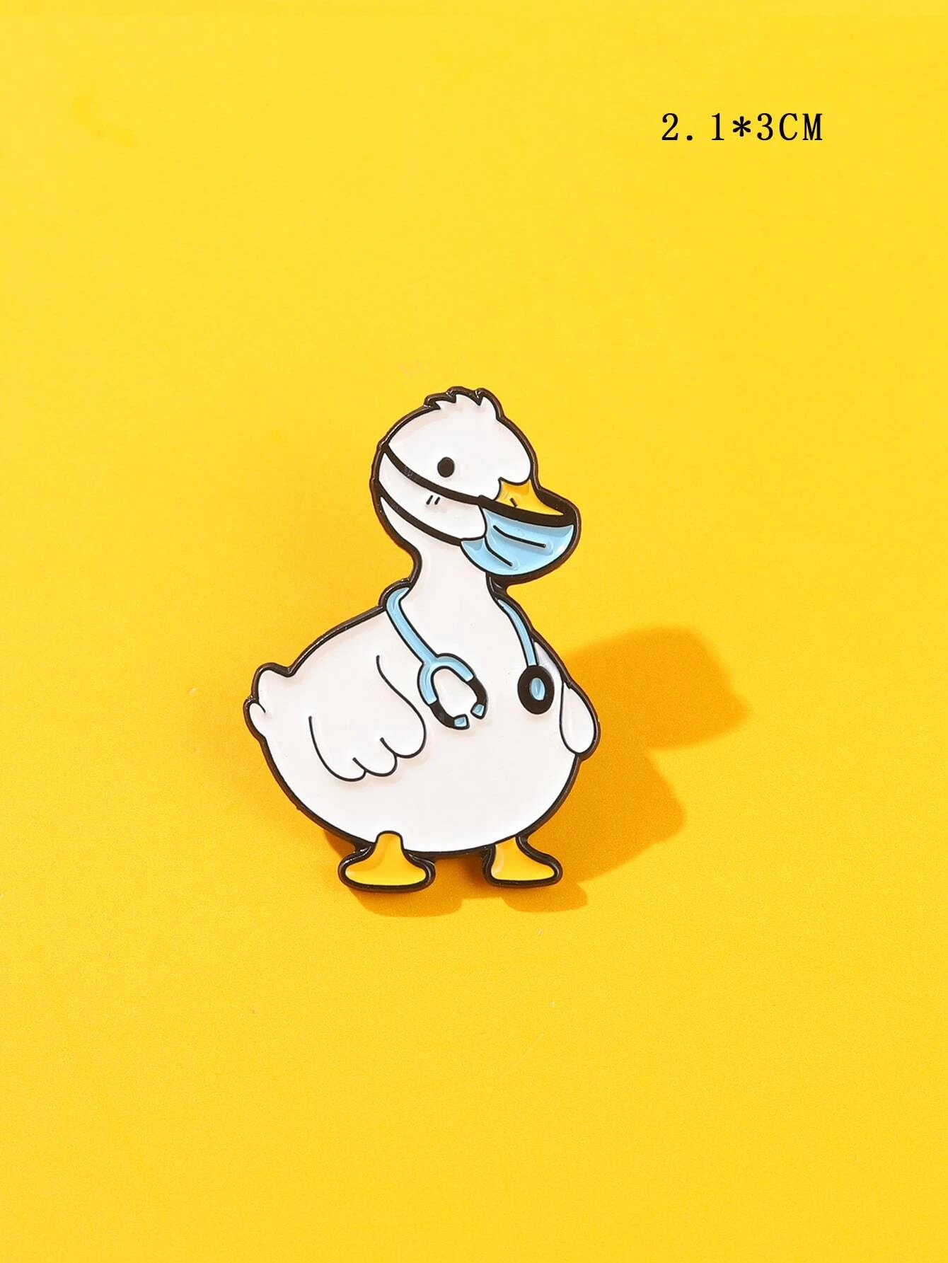 Colorful cartoon duck brooch with a cheerful expression, vibrant yellow feathers, an orange beak, and large, expressive eyes. The brooch is intricately designed, capturing the playful nature of a duck in a whimsical and artistic style.