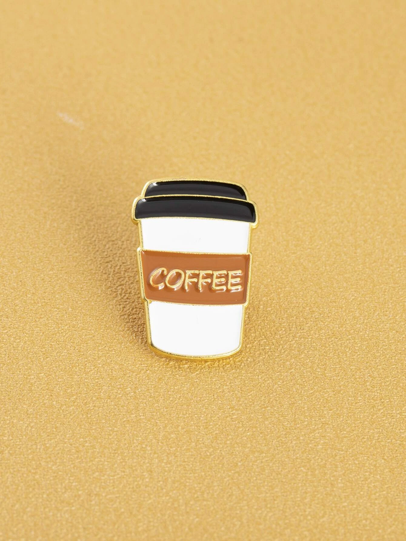 Whimsical coffee design brooch, capturing the essence of everyone's favorite beverage with artistic flair. The brooch features intricate details and playful elements that showcase a coffee cup or beans, making it a charming and delightful accessory for coffee enthusiasts or those who enjoy a touch of caffeinated creativity.