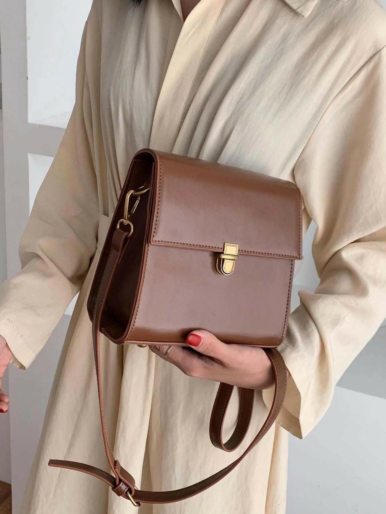 Push lock crossbody bag with minimalist design. This accessory combines practicality with clean lines, offering a sleek and versatile way to carry your essentials.