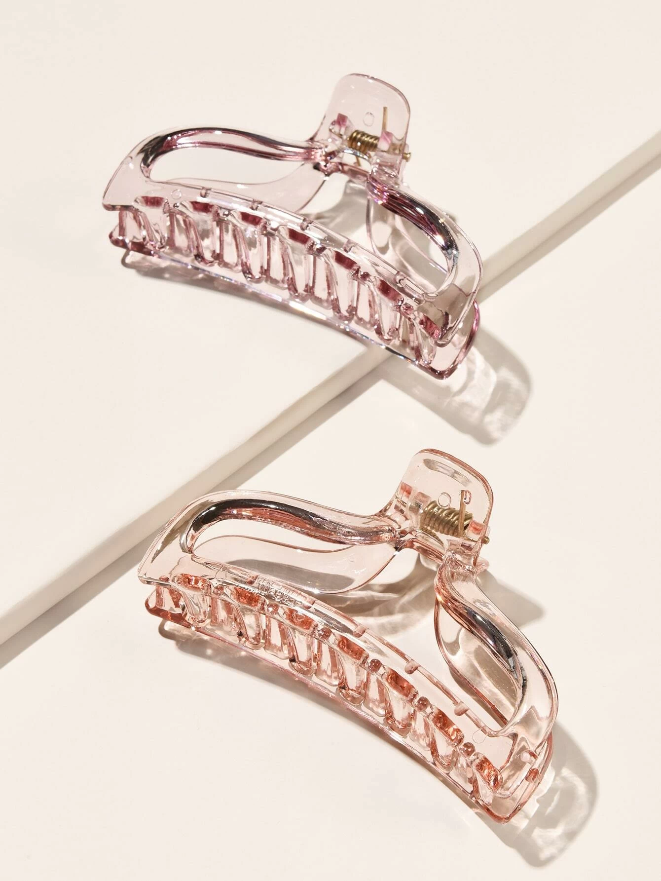 Set of two transparent hair claw clips, offering a versatile and functional accessory to secure your hair in various styles.