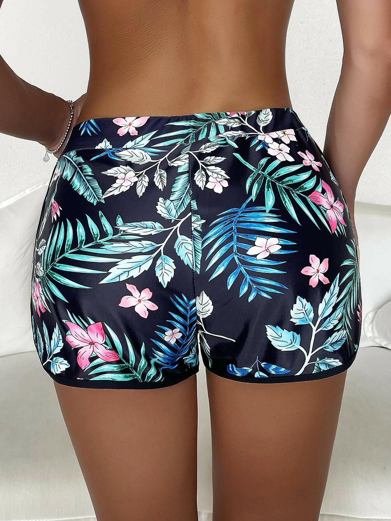 Tropical print swim shorts with vibrant and exotic patterns. These swim shorts showcase a lively tropical design, perfect for a beach or poolside vibe. The vibrant print adds a touch of color and energy to the swimwear, making them a stylish and eye-catching choice for water-related activities.