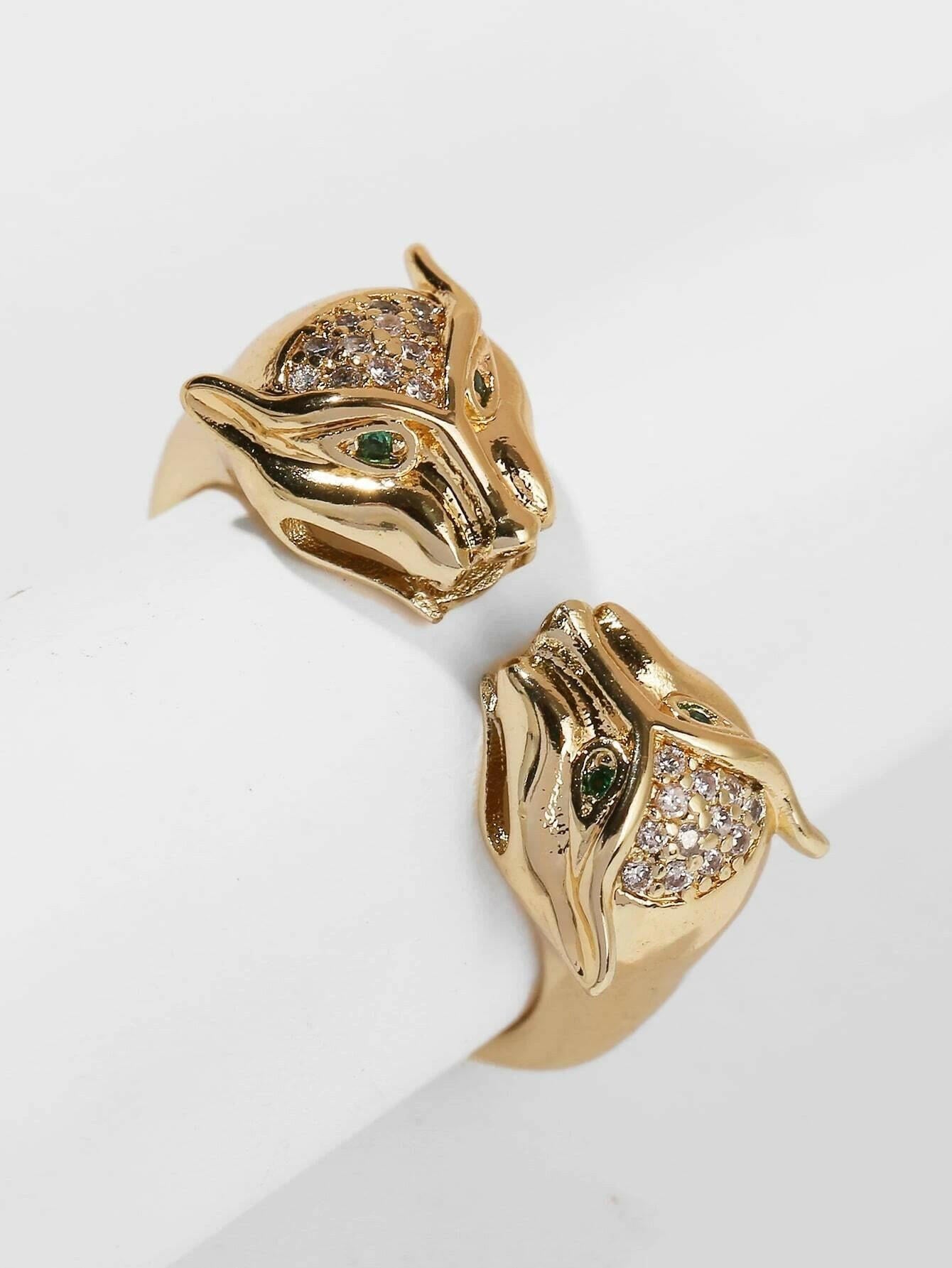 A chic cuff ring adorned with zircon gemstone decor, featuring intricate details. The ring showcases zircon gemstones set within an elegantly designed cuff-style band. The combination of the shimmering gemstones and the sleek metal creates a captivating and fashionable look. This cuff ring is a stylish and versatile accessory that adds a touch of elegance and glamour to any outfit.