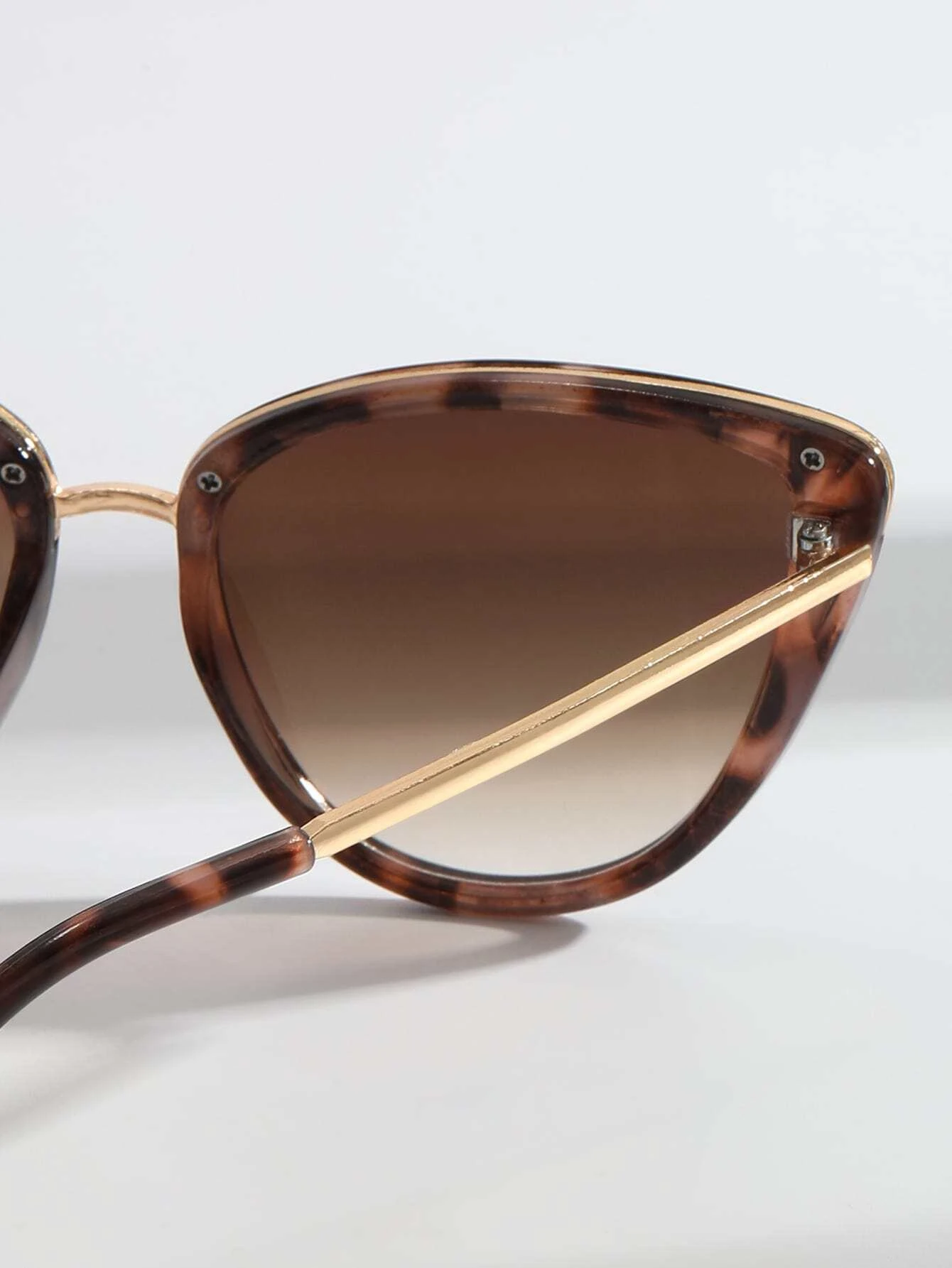 Pair of Cat Eye Tinted Lens Sunglasses with a stylish and bold design. These sunglasses showcase the iconic cat-eye frame shape and feature tinted lenses, providing both fashion and sun glare protection.