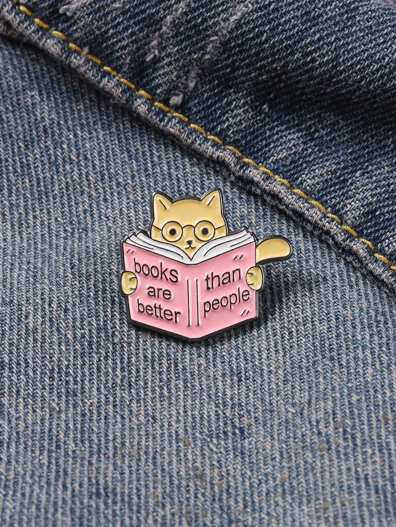 A brooch designed in the shape of a book, adding a literary and intellectual touch to your attire or accessories.