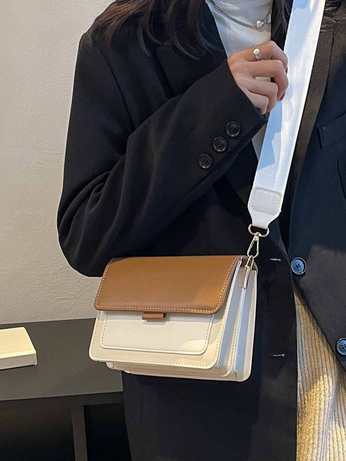 Mini square bag with color block flap design. This accessory combines modern design with vibrant color contrasts, offering a chic and stylish way to carry your essentials.