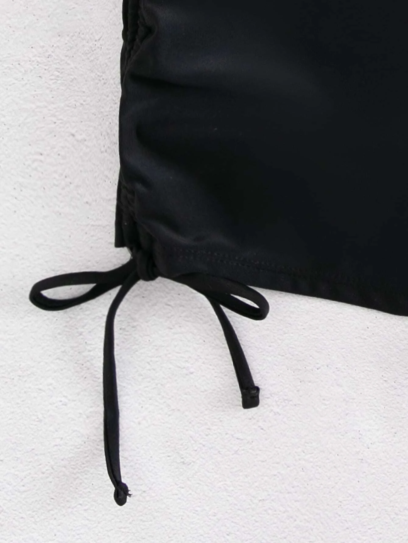 Bikini shorts with drawstring sides for adjustable fit. These shorts feature a versatile design with adjustable drawstring sides, allowing for a customizable and comfortable fit. The shorts are ideal for beach or pool activities and offer a trendy and practical swimwear option. The drawstring detail adds a touch of style while ensuring a secure and personalized fit, making these shorts a fashionable choice for any water-related outing.