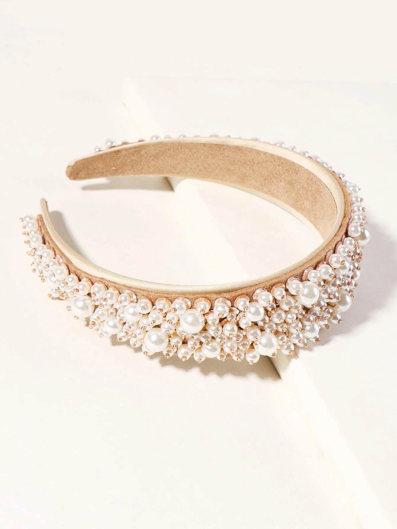 A hair hoop adorned with faux pearl beads, providing a chic and elegant accessory for your hair styling.