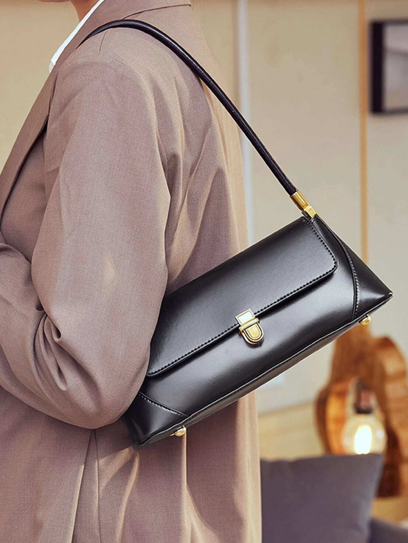 Flap baguette bag with minimalist design. This accessory offers a sleek and stylish way to carry your essentials, embodying modern elegance and functionality.