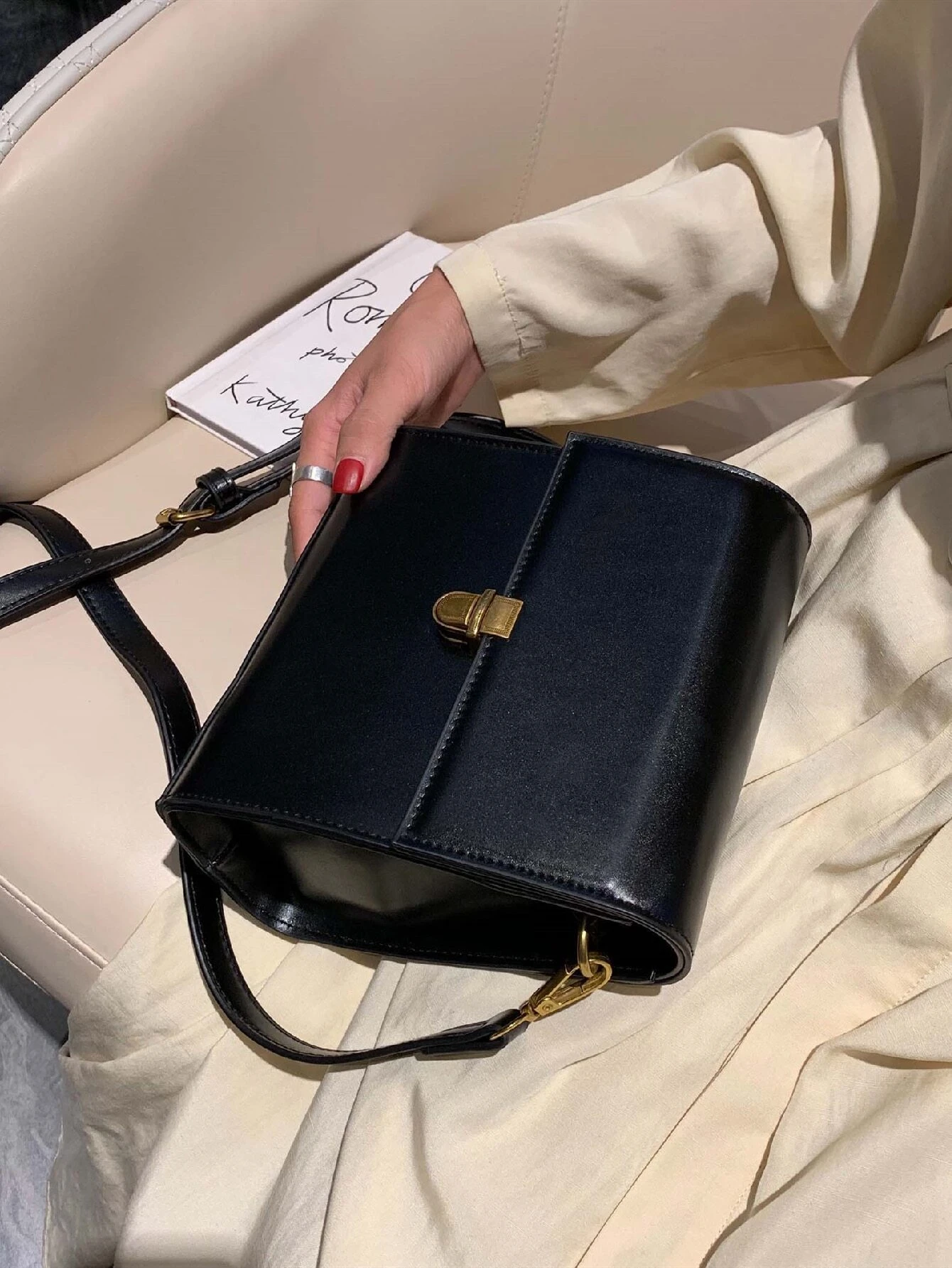 Mini square bag with minimalist design and snap button detail flap. This accessory combines simple elegance with functional embellishments, offering a chic and versatile way to carry your essentials.